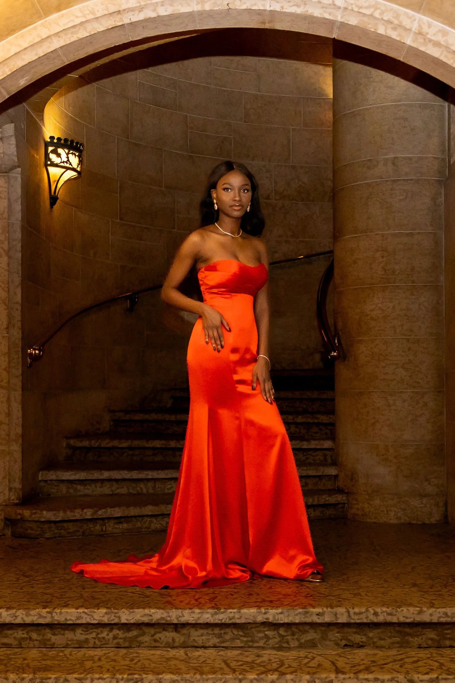 Woman wearing a red satin dress with floor length skirt, at Banff Hotel