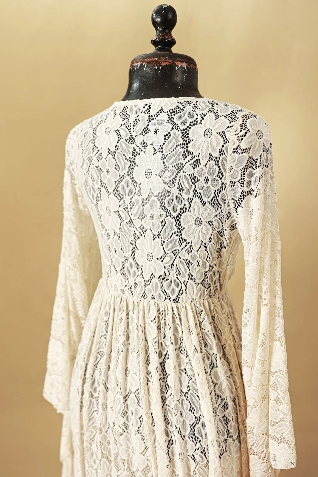 Back view of maternity photoshoot lace dress, showing floral lace embroidery