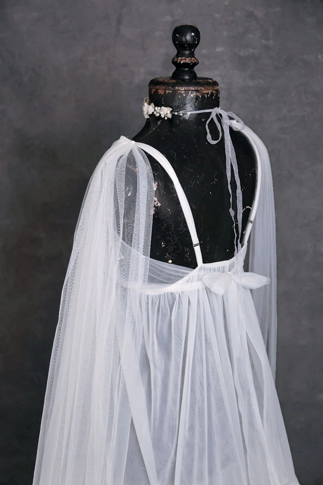 Back of KH fashion white boho sheer maternity gown, showing an open strappy back