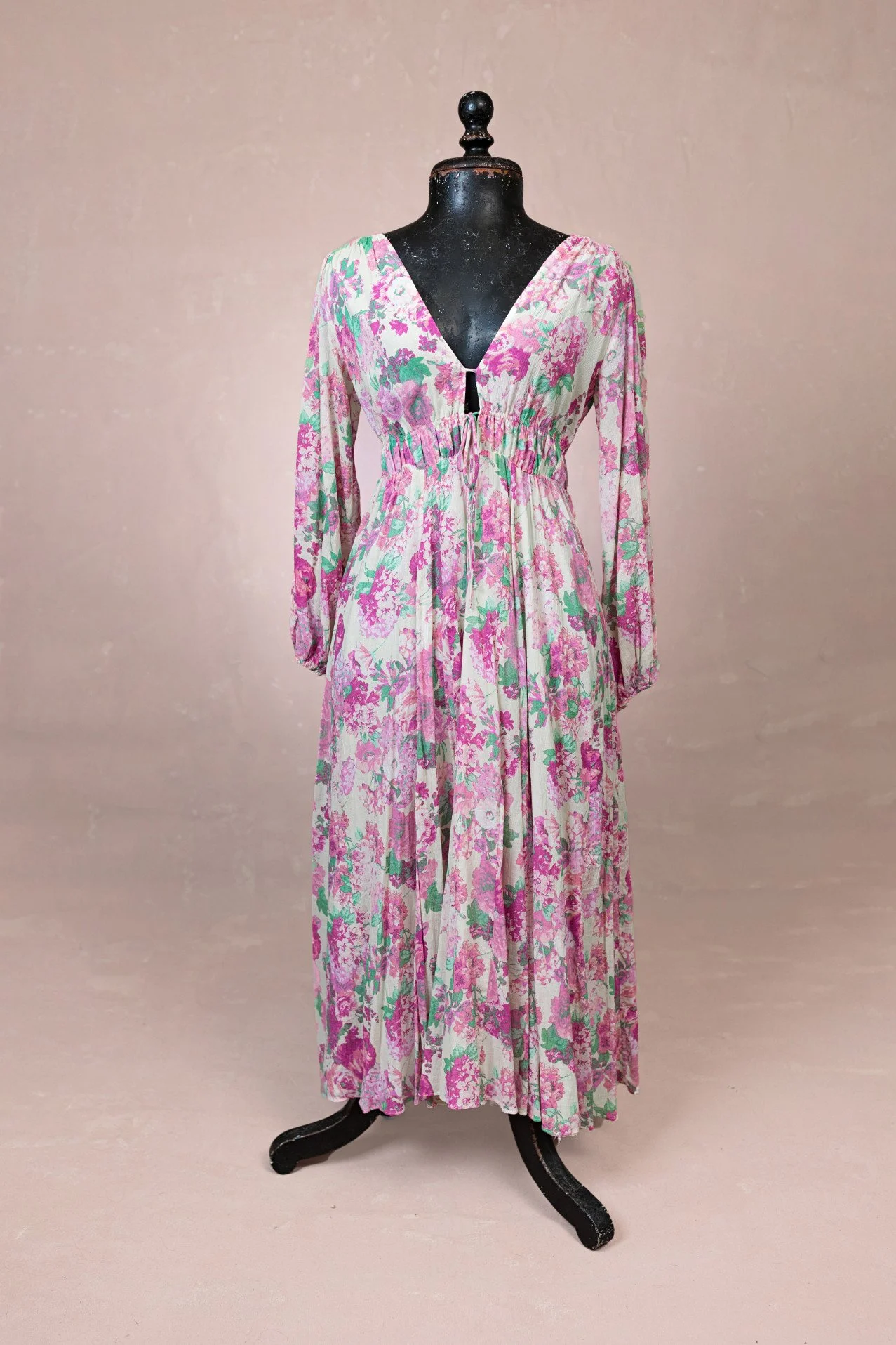A midi dress with pink peony print, long sleeves, and deep v-neck cut, for rent in Calgary