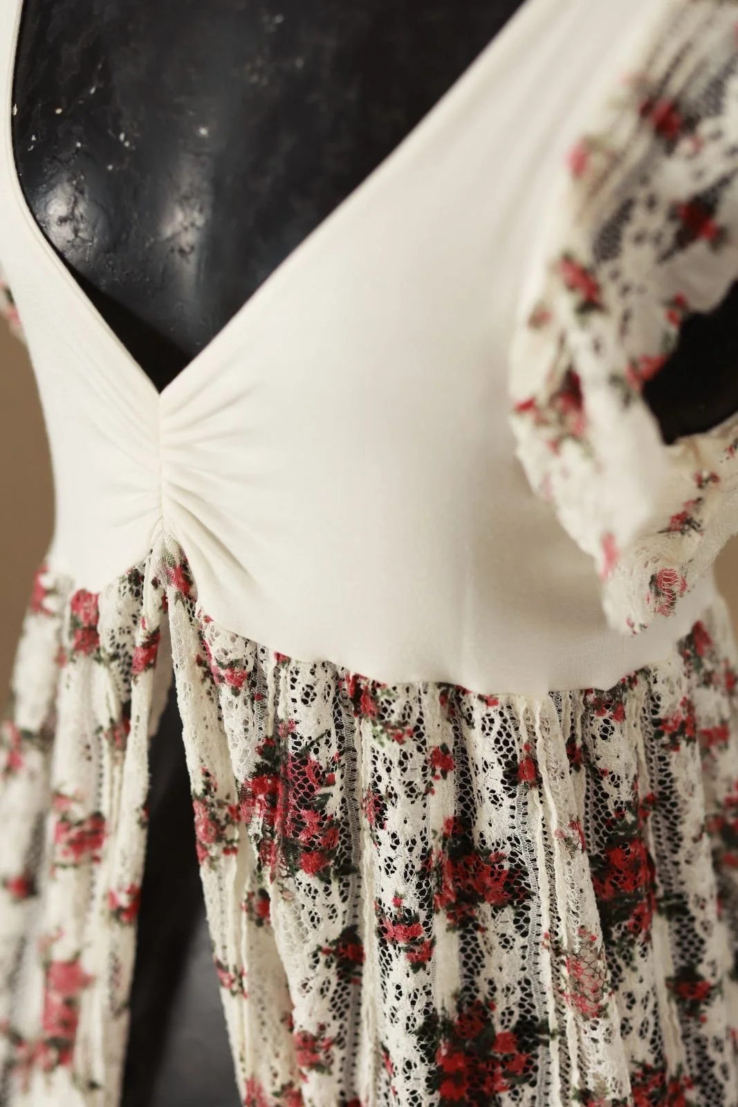 Close up showing cinched white smooth fabric top on maternity bodycon dress