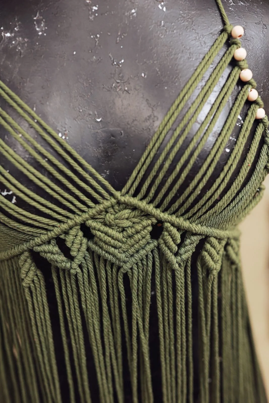 Close up of green boho rope macrame dress, showing woven bikini bust
