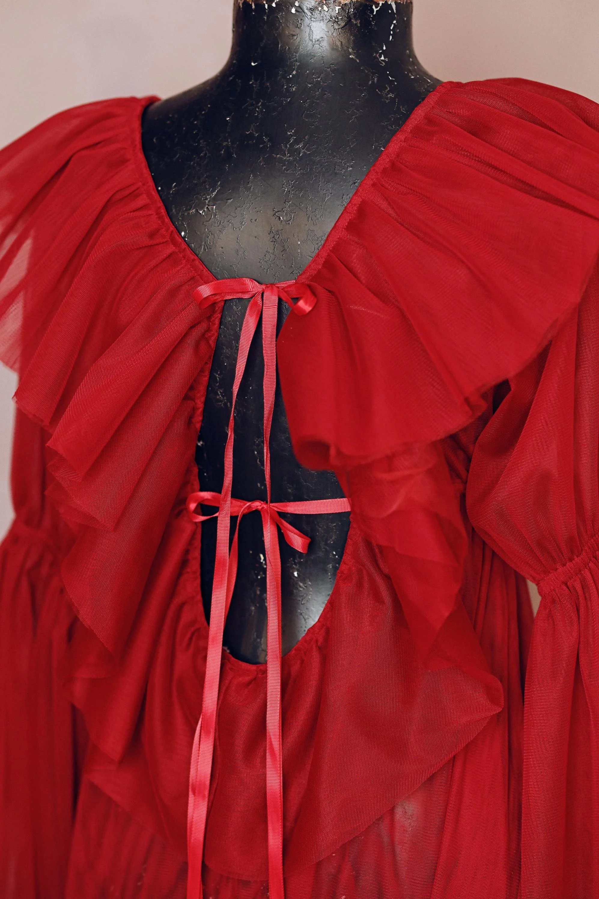 Close up of open back, on a red boudoir maternity photoshoot robe