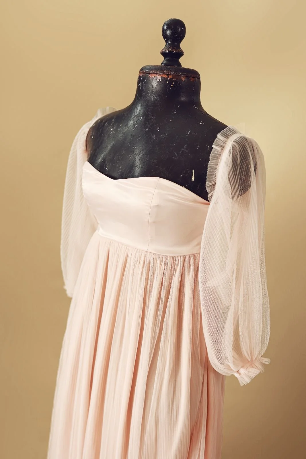 Close up of barbie pink maternity rental dress with corset and tulle sleeves