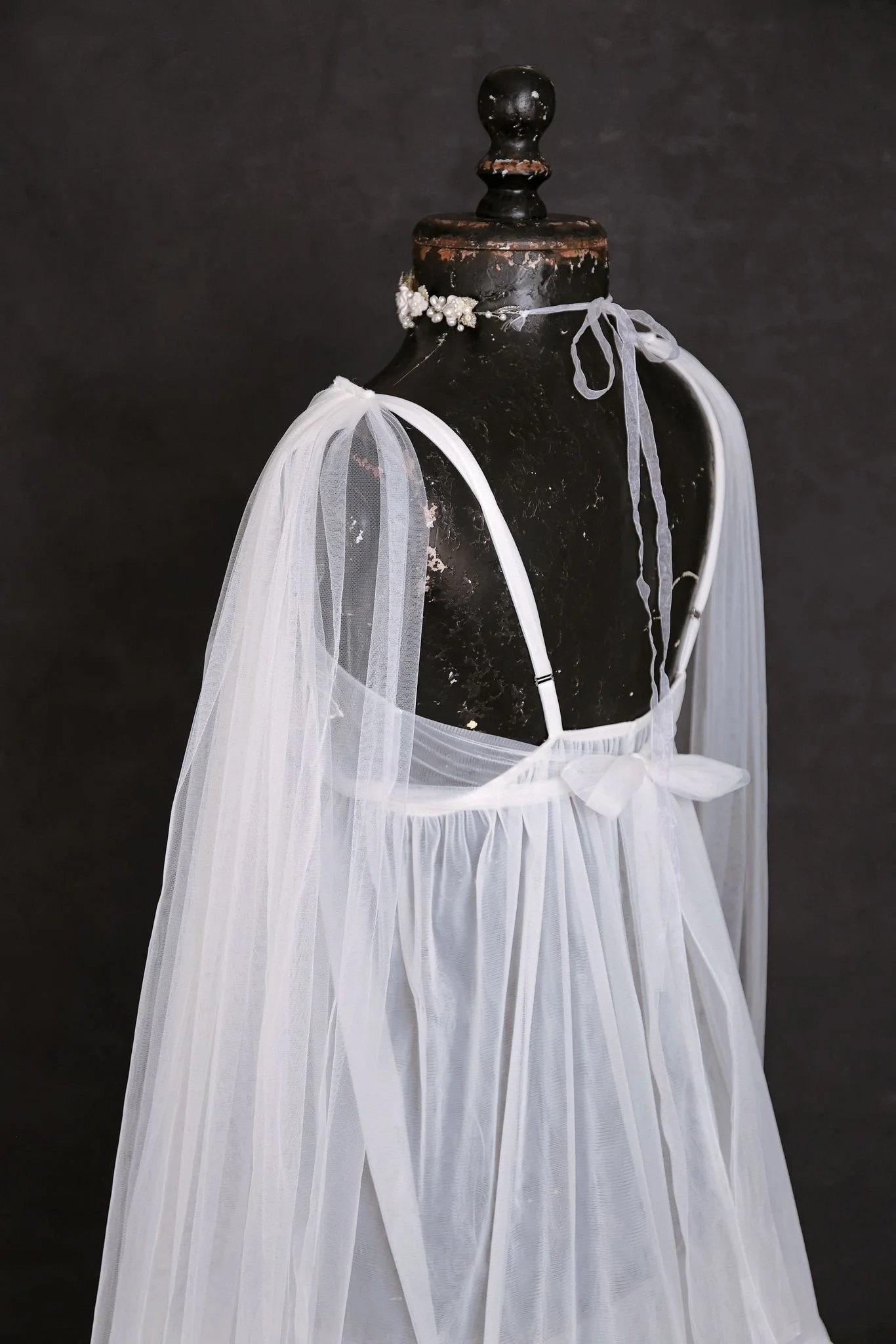 Back of KH fashion white boho sheer maternity gown, showing an open strappy back