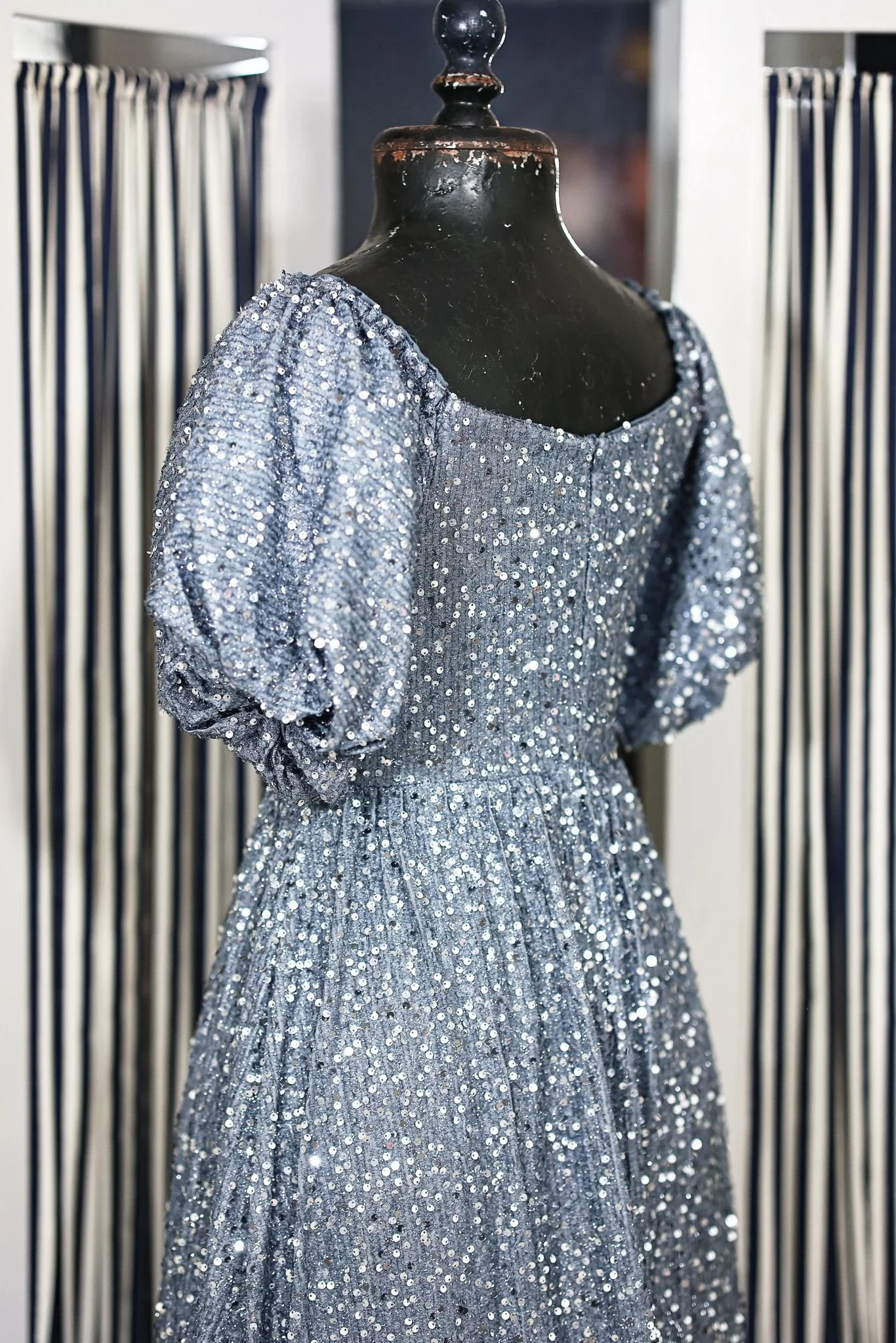 Back view of light blue sequin dress with floor-length skirt and puffy sleeves, for maternity or couples photoshoots