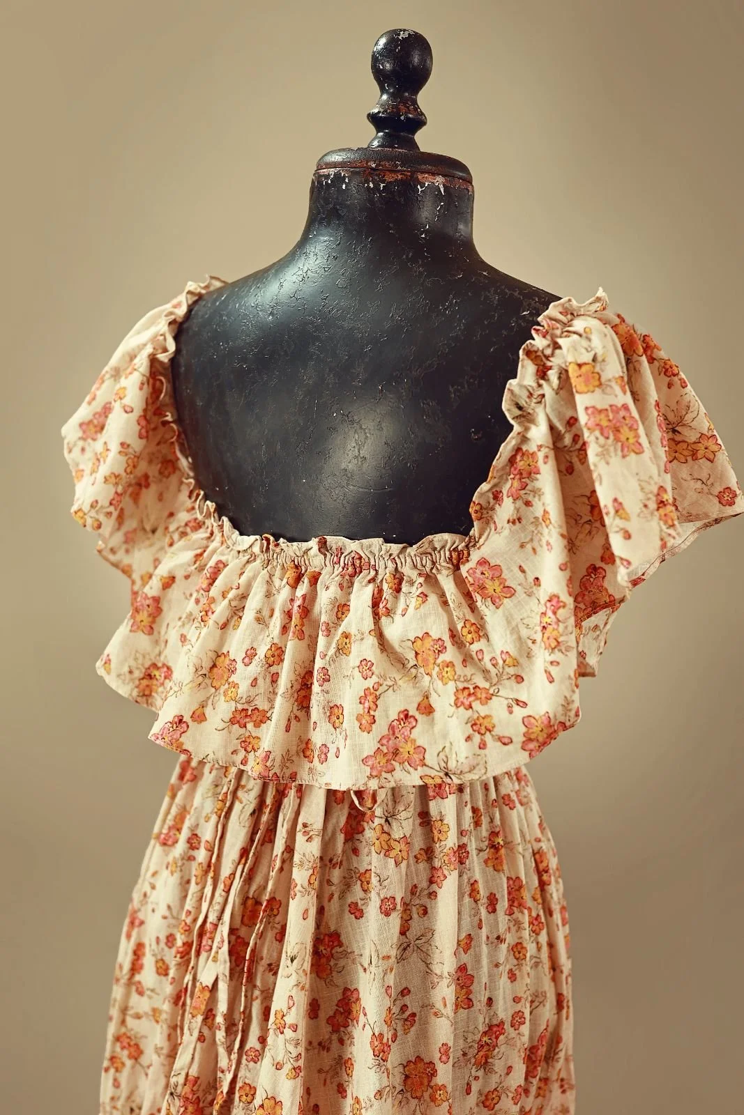 Back view of floral cotton gown for rent, showing open back