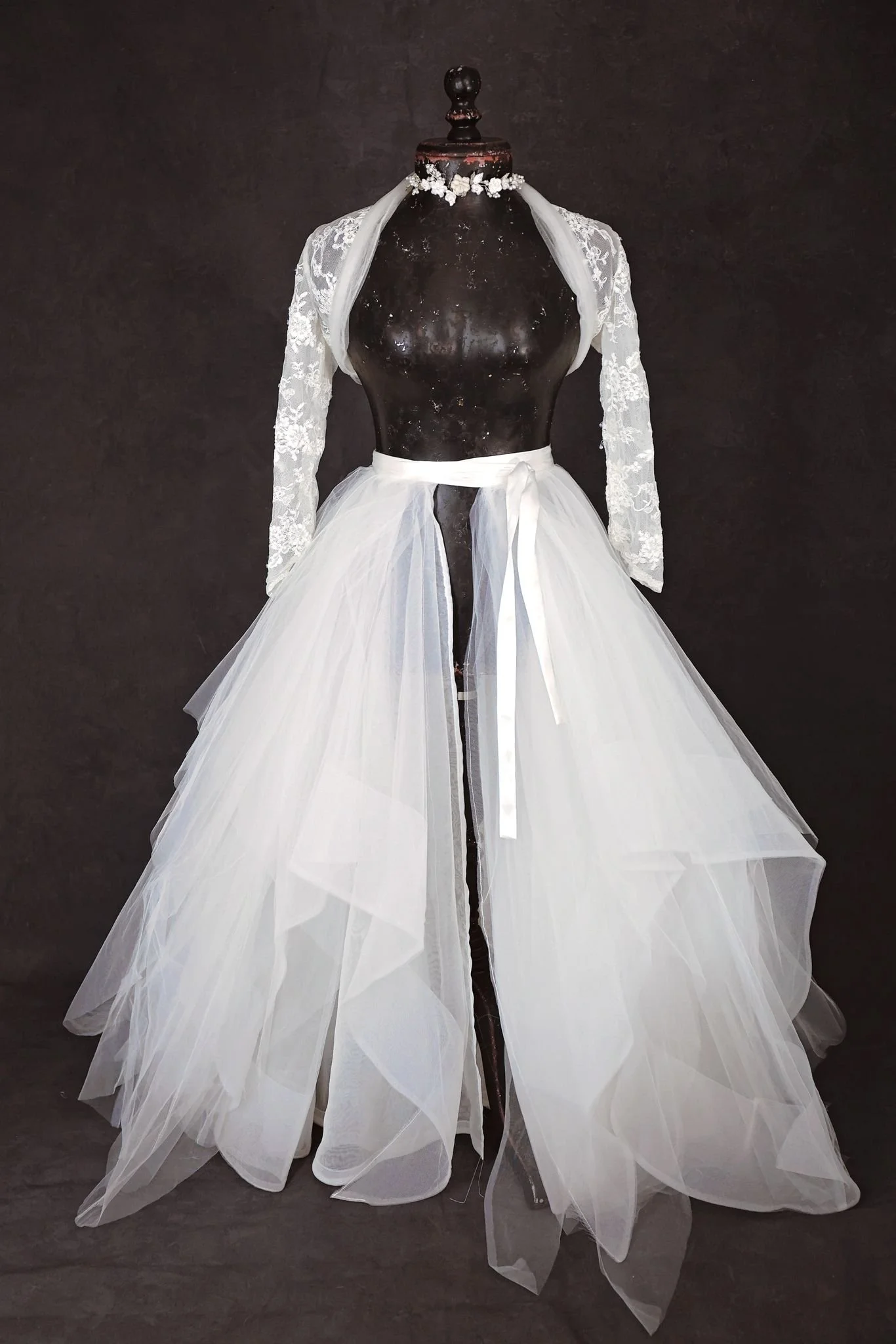 White layered textured puffy tulle skirt and white lace jacket, with silver jewellery ribbon