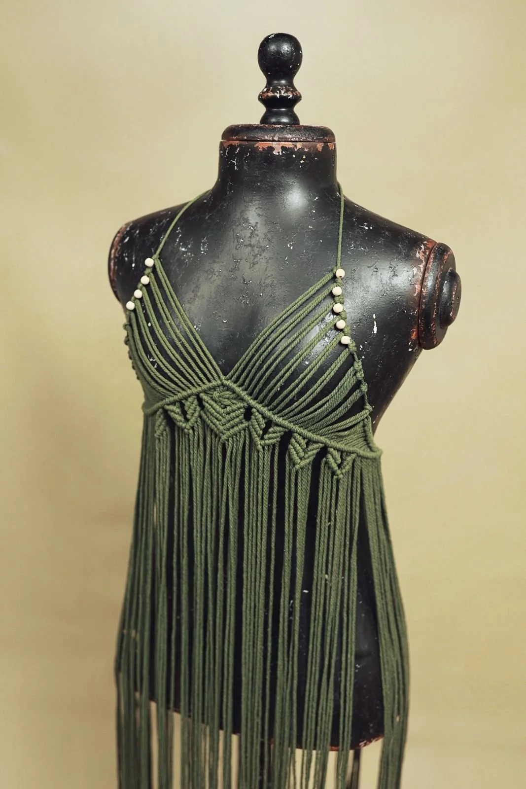 Close up of maternity rental macrame dress, with woven rope and sleeveless cut