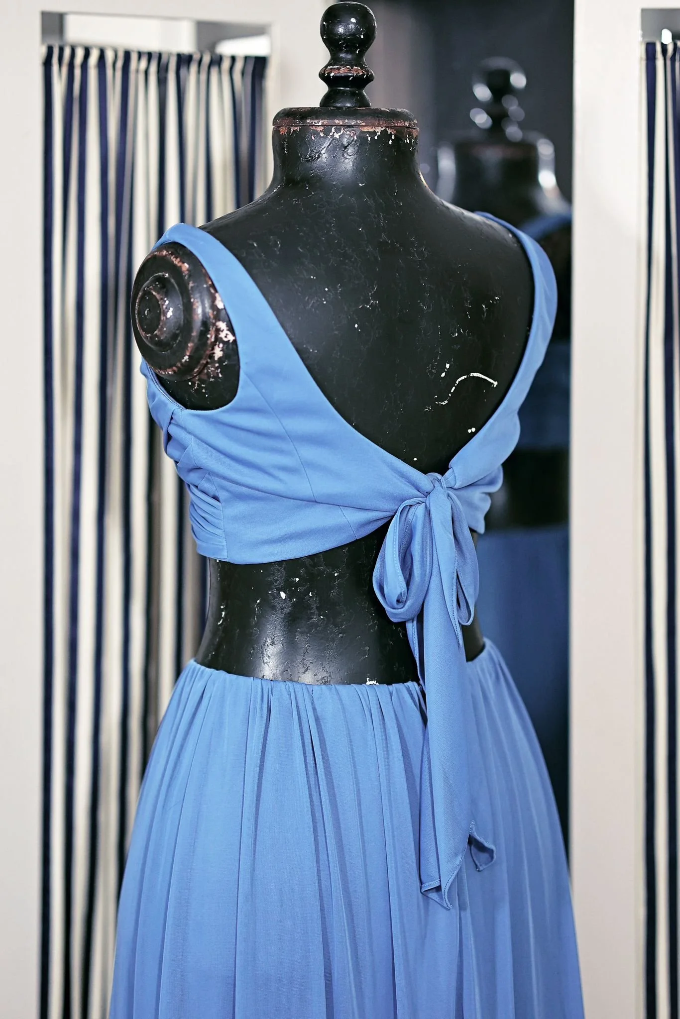 Close up of two-piece dress, showing tie at the back of the blue top