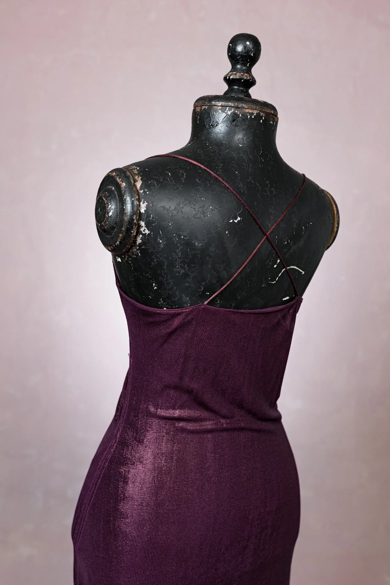 Back view of bodycon burgundy red dress, showing open shoulders with strappy design