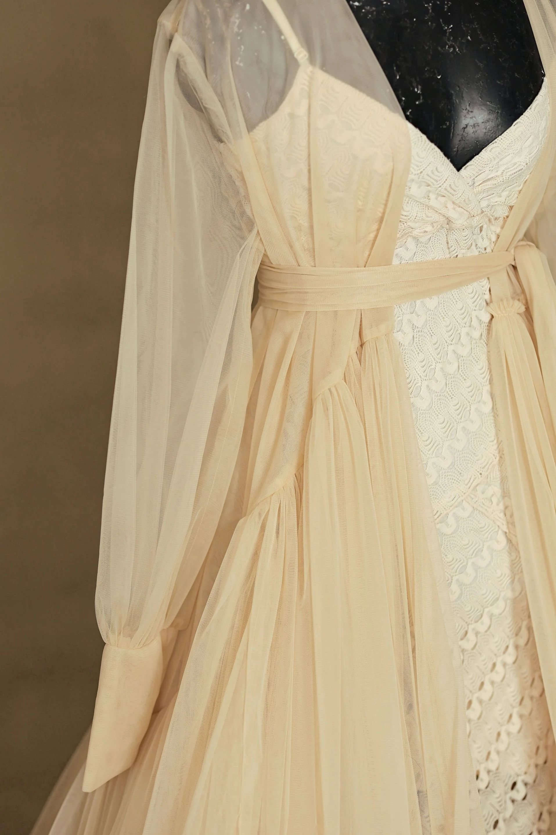 Close up of yellow tulle floor-length robe combined with a white lace sleeveless dress