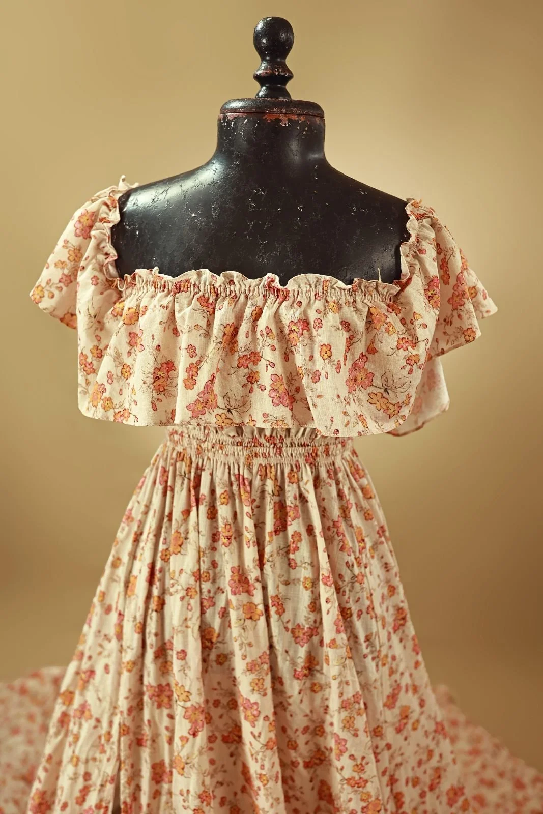 Close up of floral cotton gown, showing ruffled shoulders