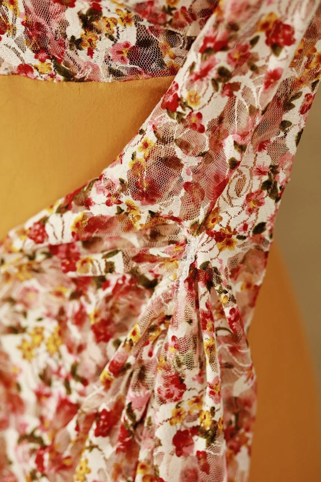 Close up of gown sleeves, with floral patterns and textured fabric design