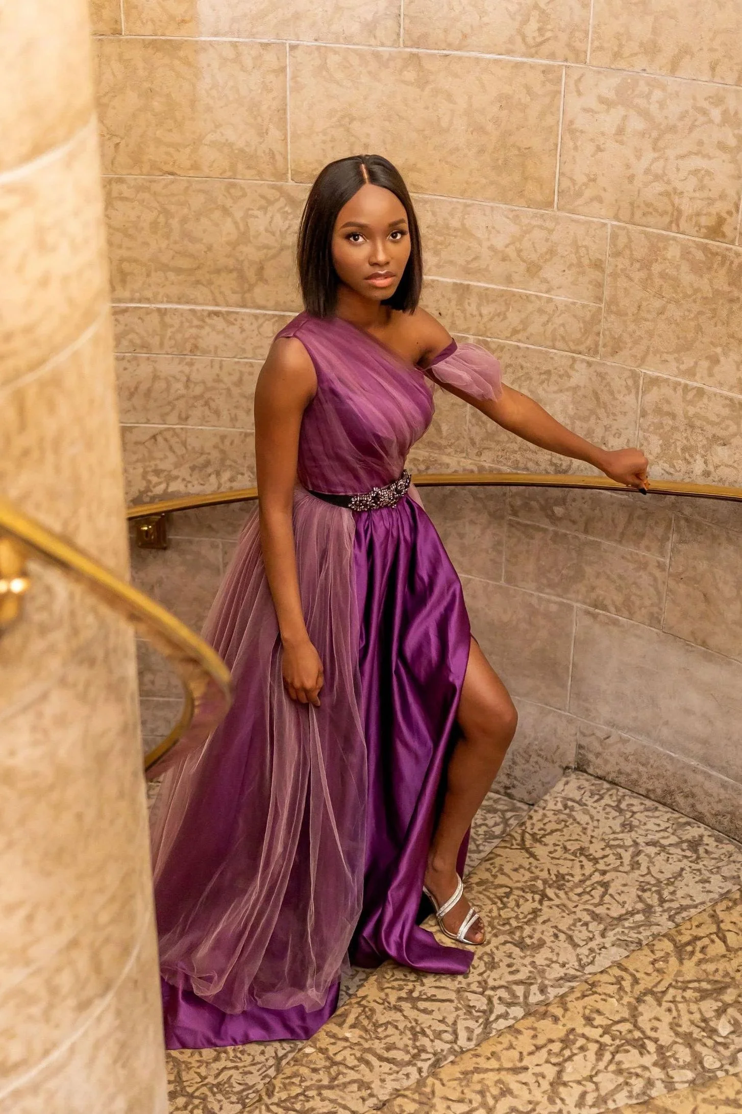 Woman wearing a purple satin dress with tulle tail and jewellery belt at Banff Hotel