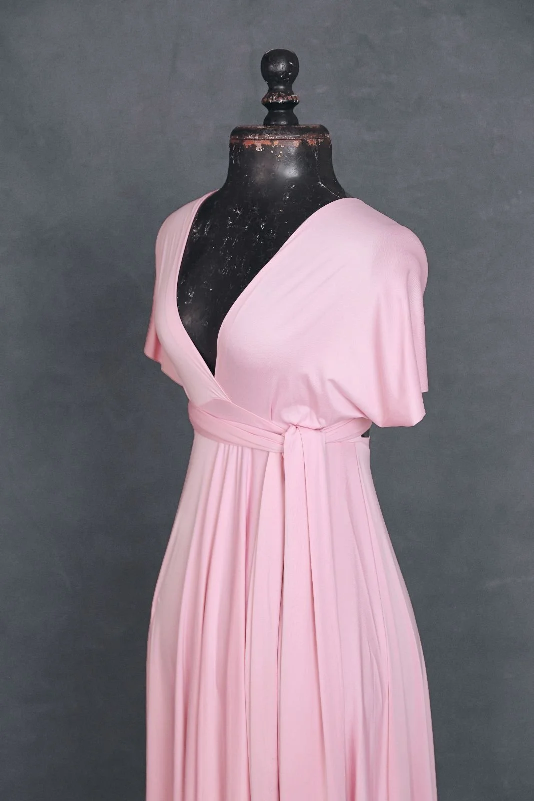 Side close up of a pink photoshoot infinity dress with a V-neck cut