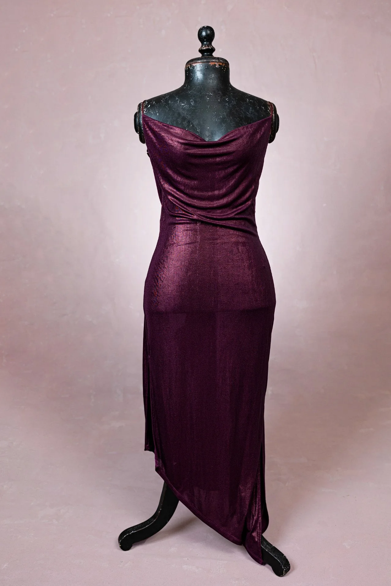 A burgundy red bodycon dress with cowl neck, strappy shoulders, asymmetrical skirt, for rent in Calgary