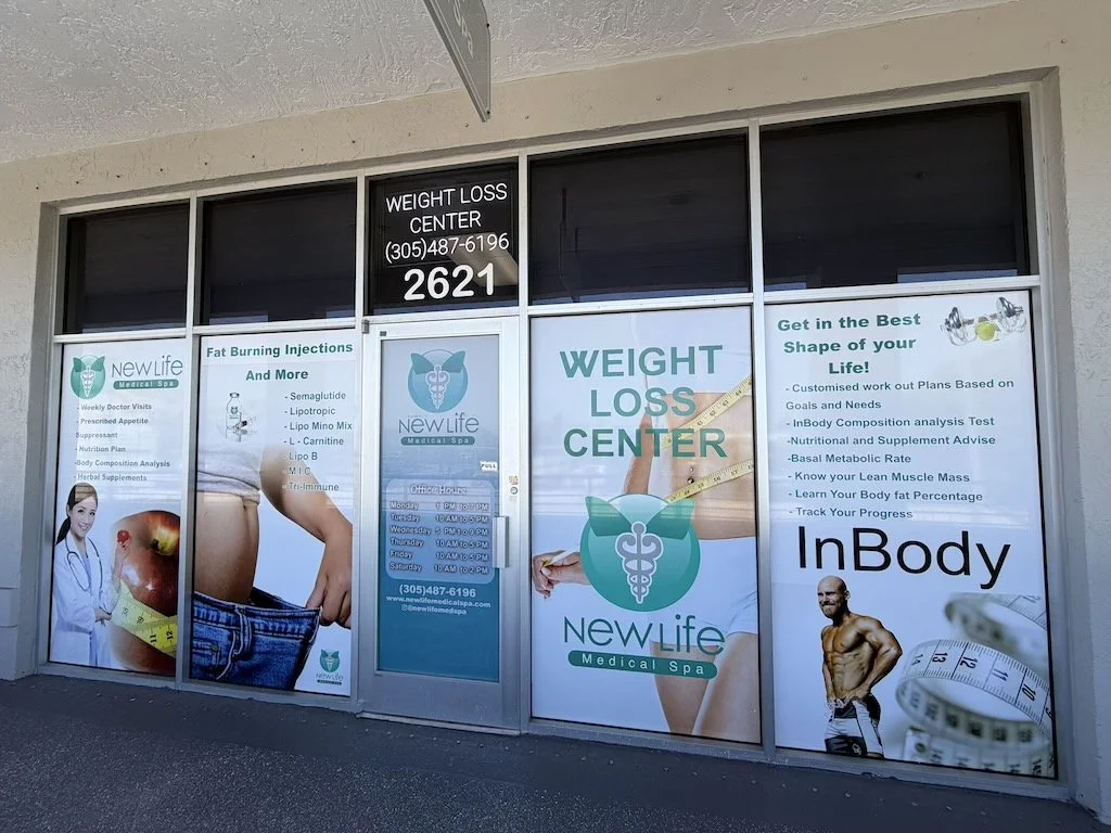 Storefront for New Life Medical Spa offering weight loss services, with signs advertising fat burning injections, custom workout plans, body composition analysis, and other health programs.