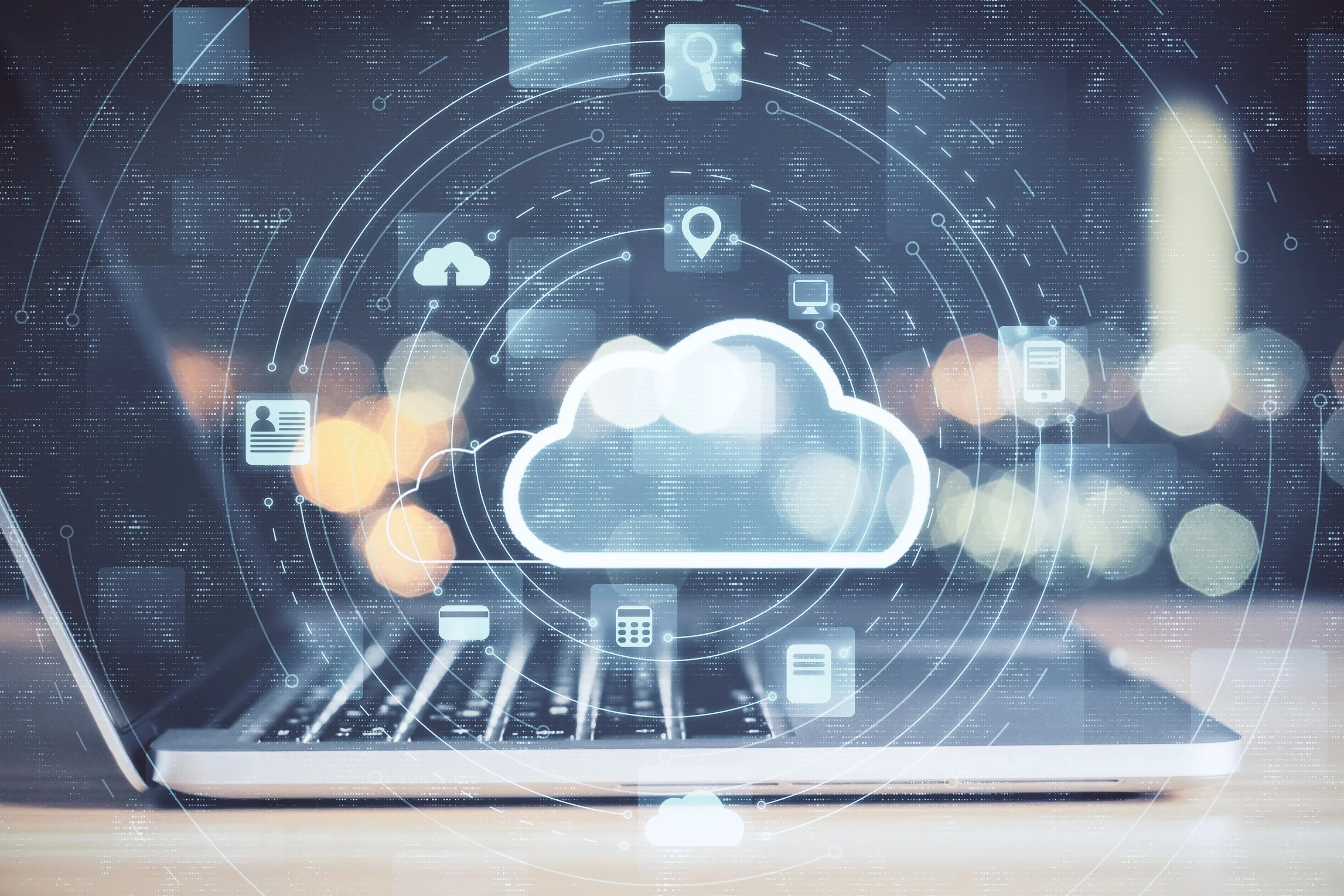 Laptop with cloud computing icons overlay, representing data storage and technology.
