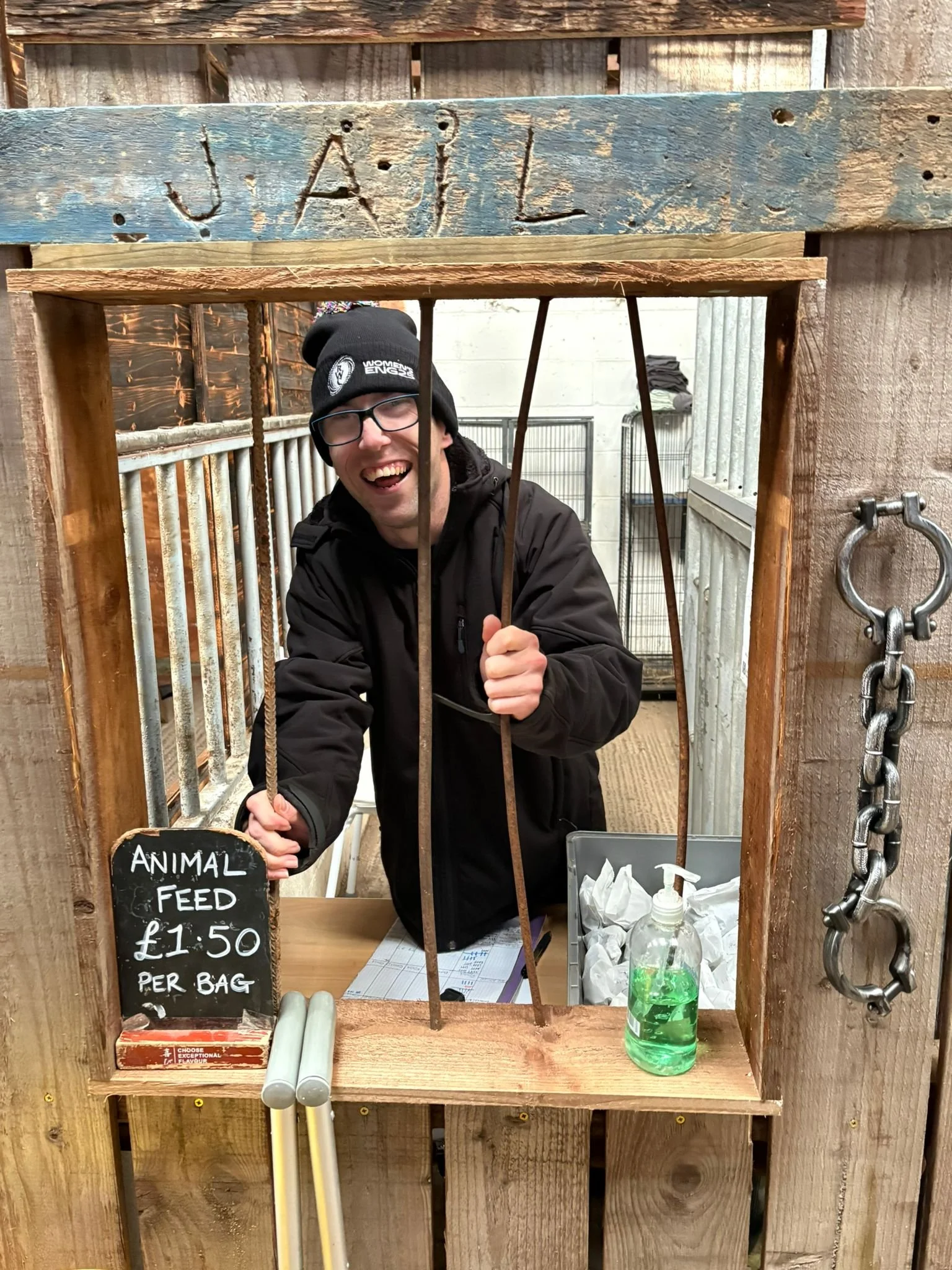 Mathew standing behind the jail bars in the food kiosk