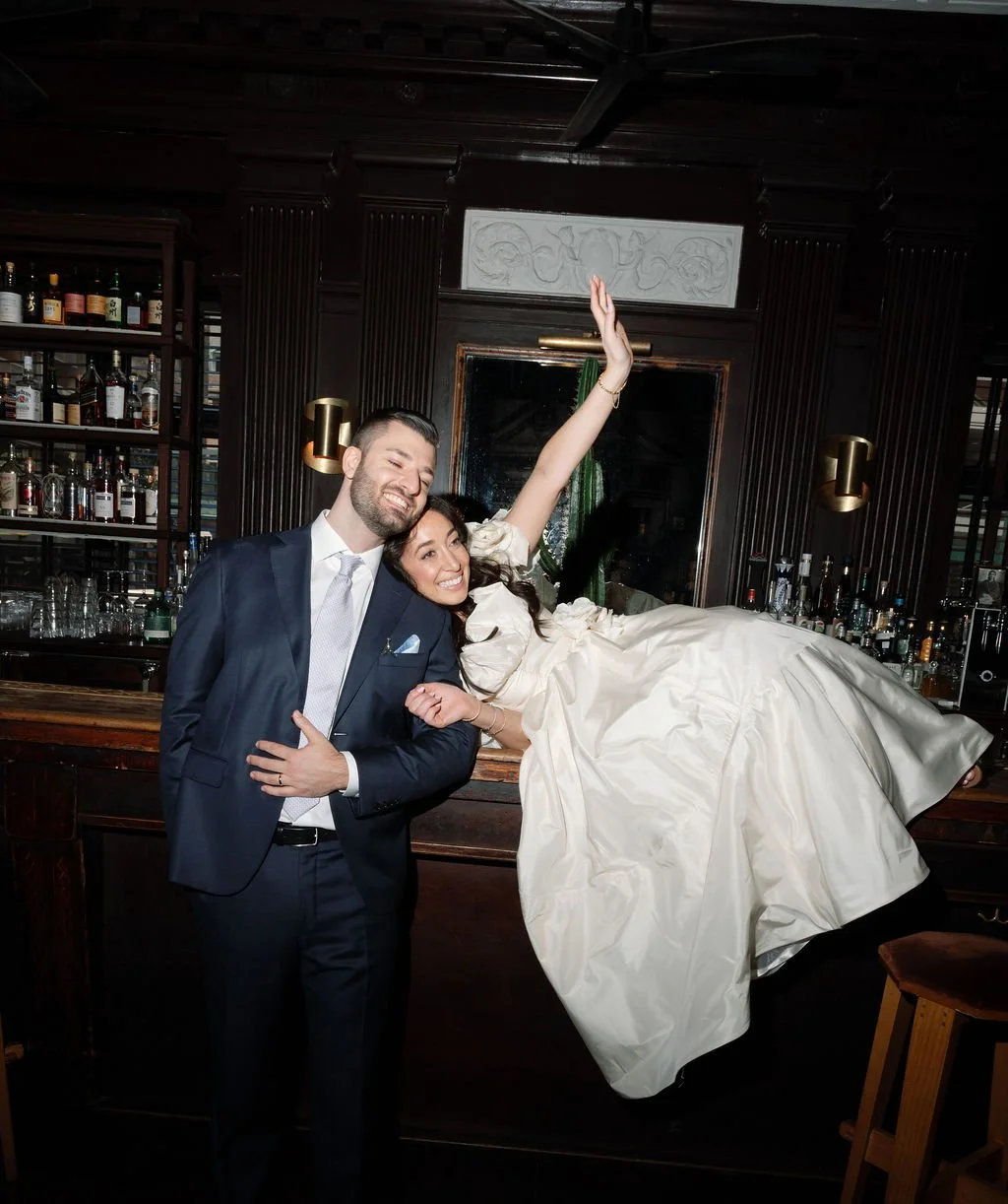 A wedding couple posing post ceremony in Bar Calico