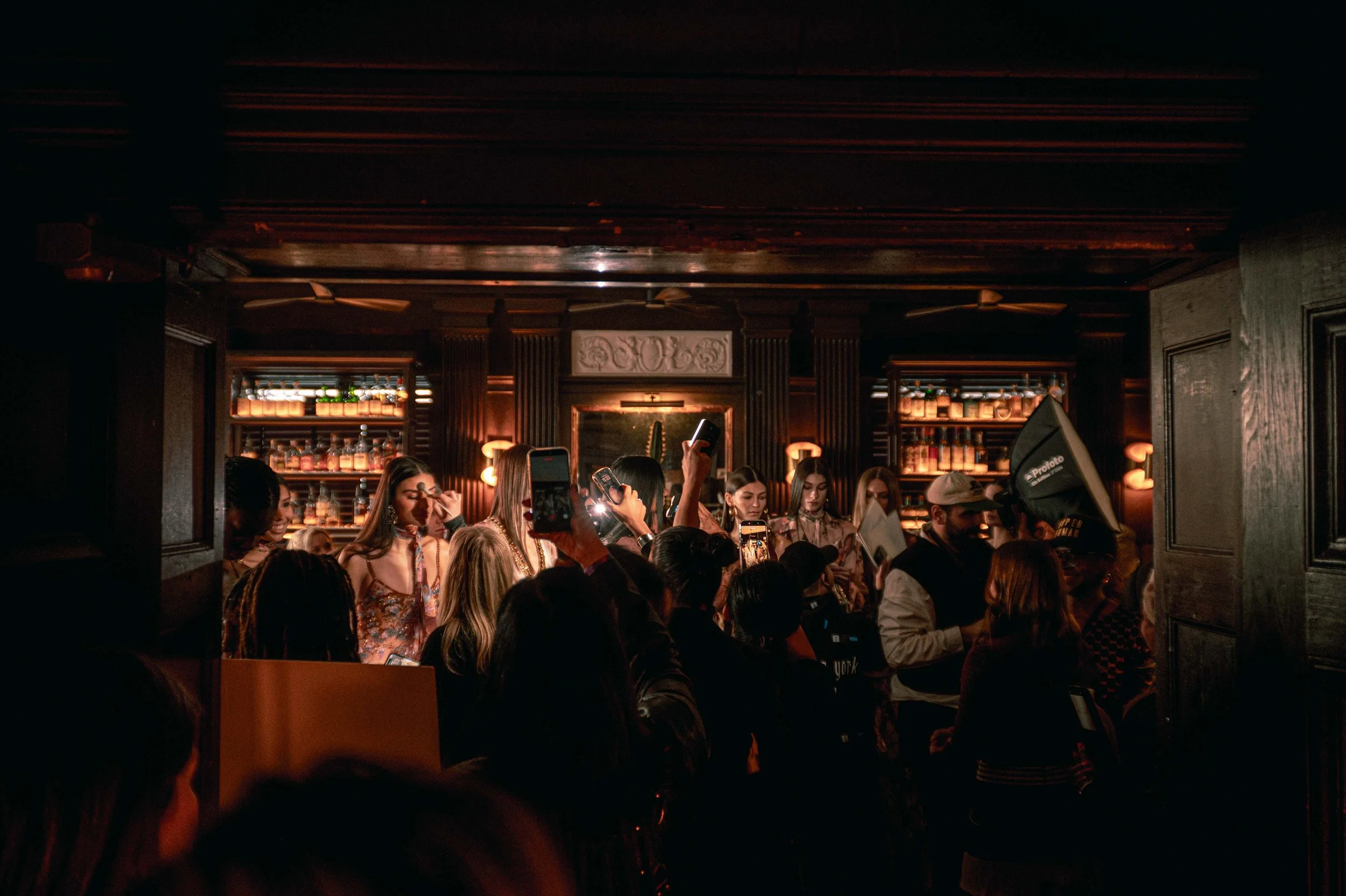 Behind the scenes moments of models getting hair and makeup done in Bar Calico before walking in the PatBO NYFW show 