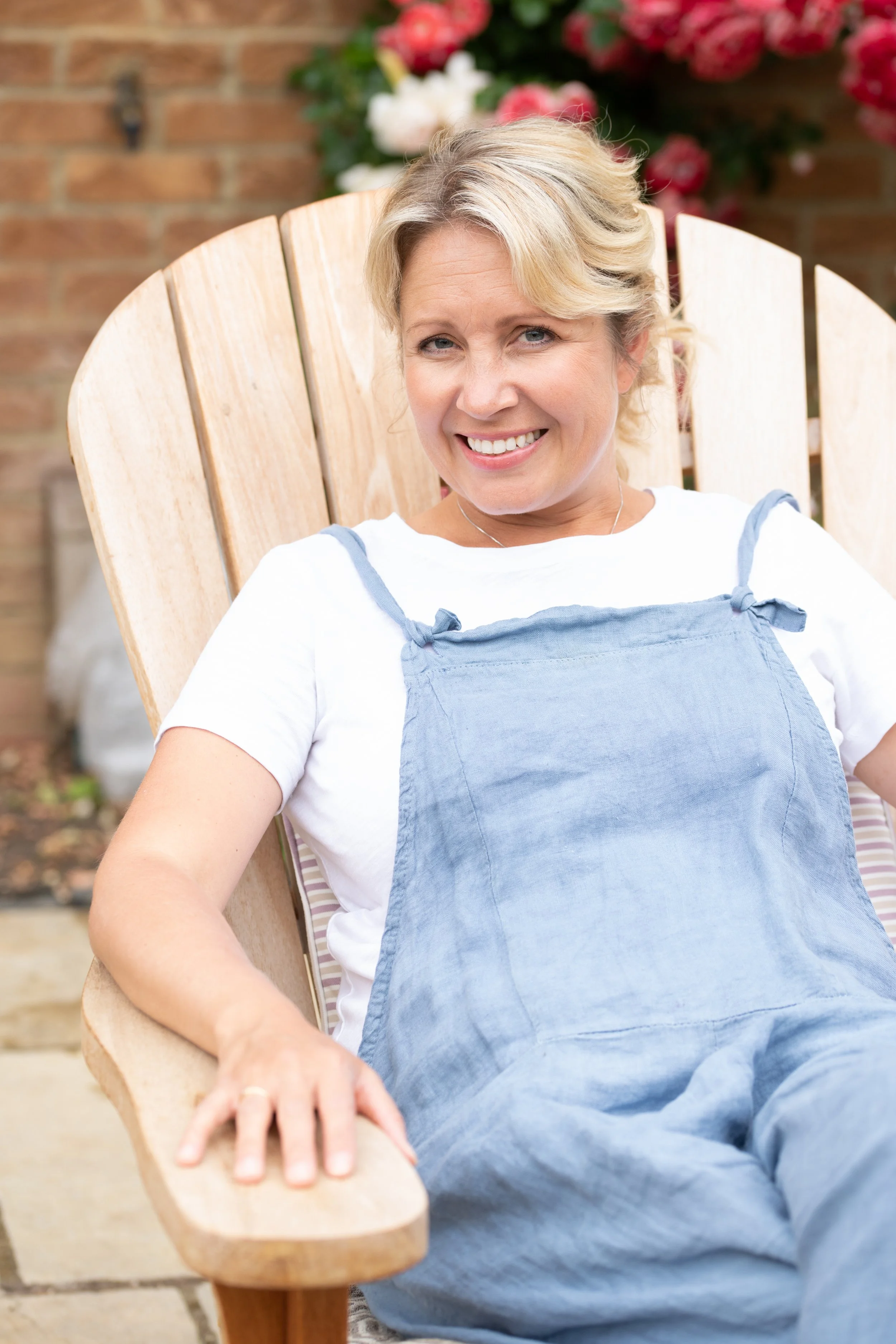 Sarah, founder of Henley Naturals, seated in a garden