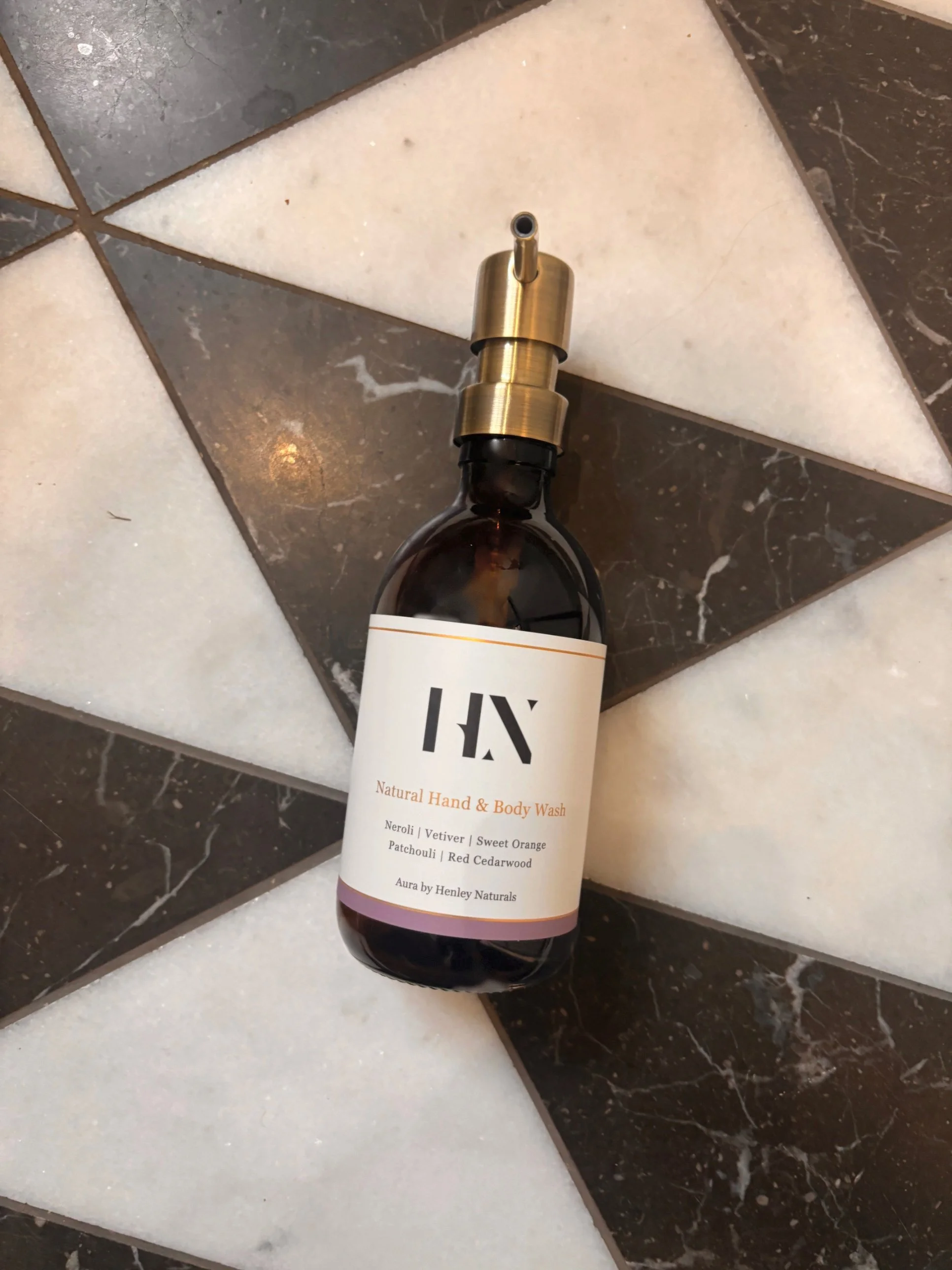 Henley Naturals hand and body wash in an amber glass bottle