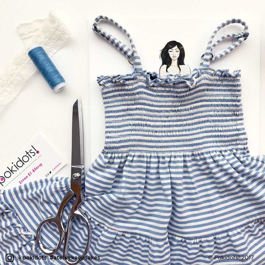 Little girl dress for first birthday party against a custom portrait of the girl