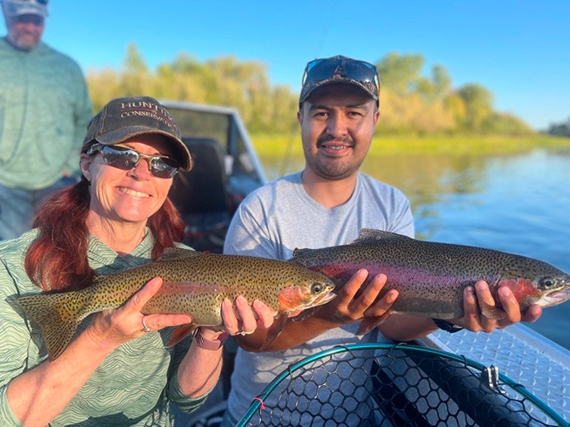 Man and woman catch a King Salmon fish on a fishing trip with fishing expert in Anderson, California