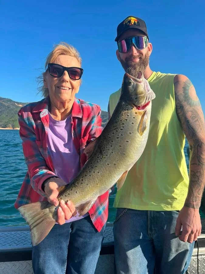 Man and woman on Shasta Lake after a day of fishing with the best fishing guide in Redding