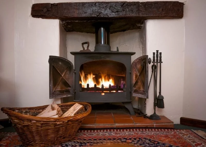free standing indoor wood stove with a tile hearth pad
