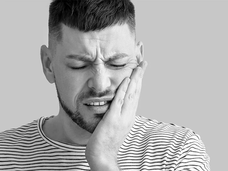 Man in pain from tooth with dental emergency in Anderson, CA