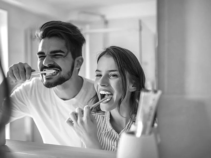 Couple brushing their teeth to prevent cavities in Anderson, California