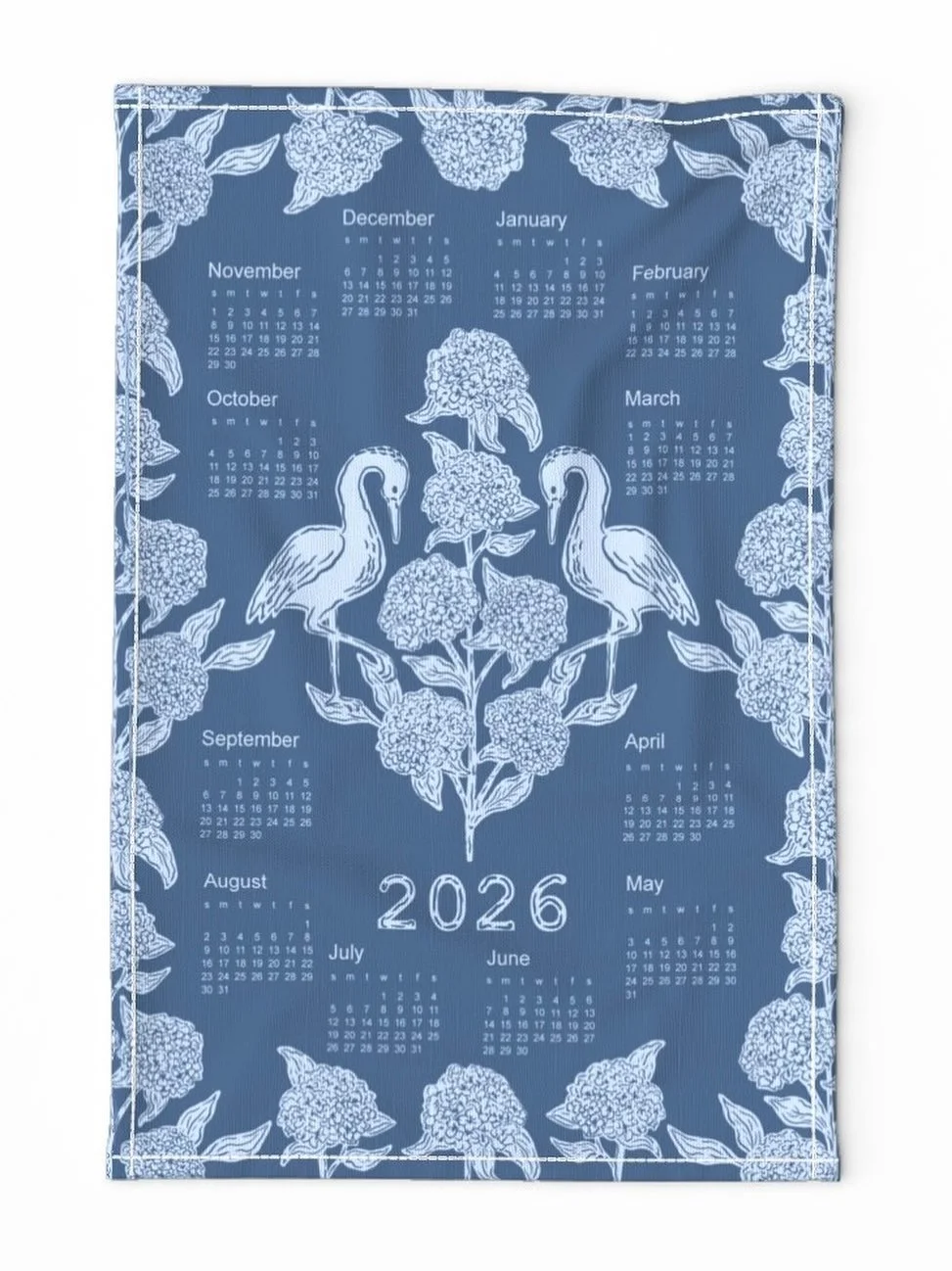 I turned my chinoiserie cranes and hydrangeas into a little 2026 tea towel calendar available now in my @spoonflower shop 💙 #homemaker #fabricwallcalendar #2026calendar #farmhousekitchendecor #chinoiseriechic