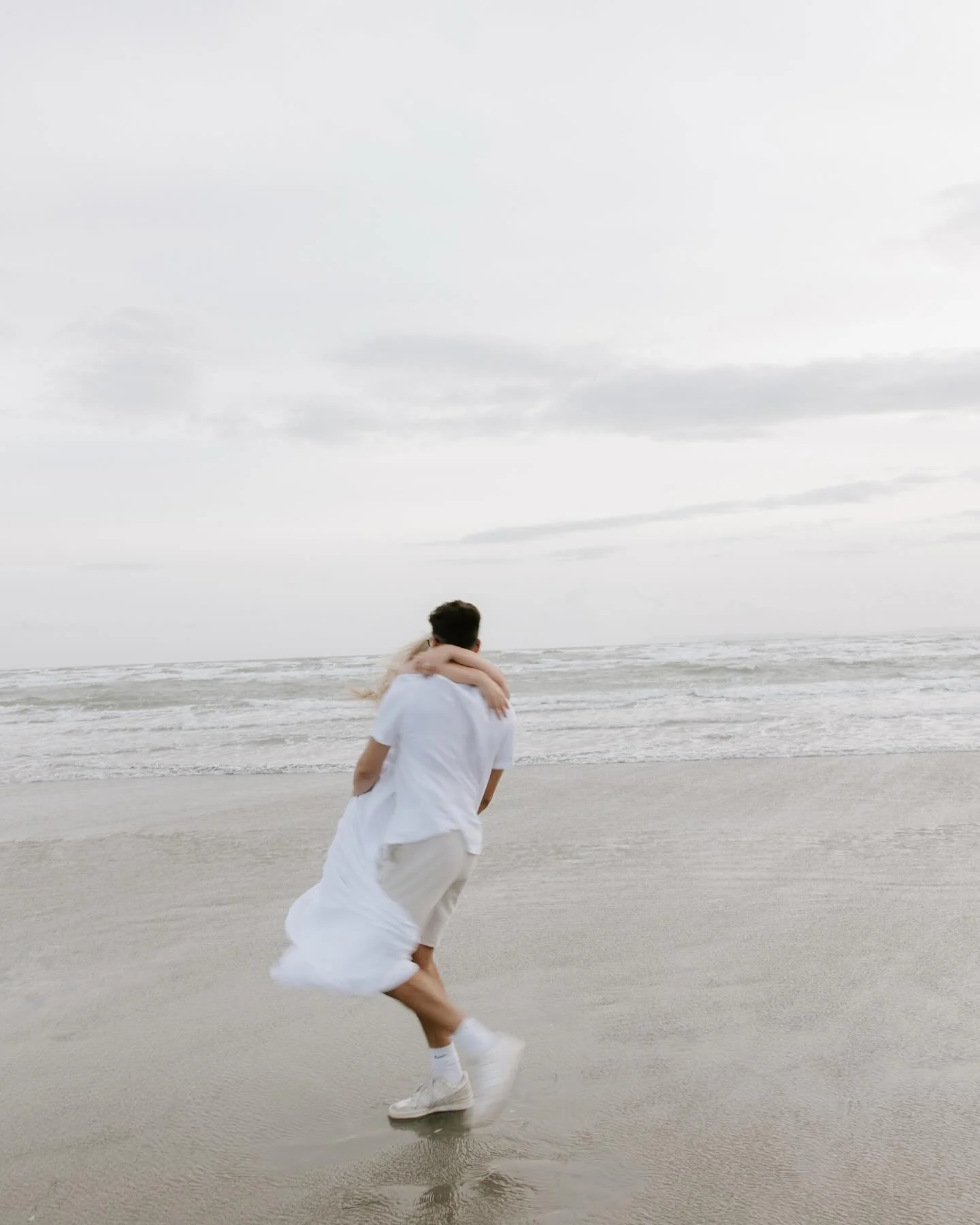 Emily &amp; Ben fully embracing the windiest beach session at West Wittering. Racing across the sand, wind in their hair and chasing that last bit of sun ✨