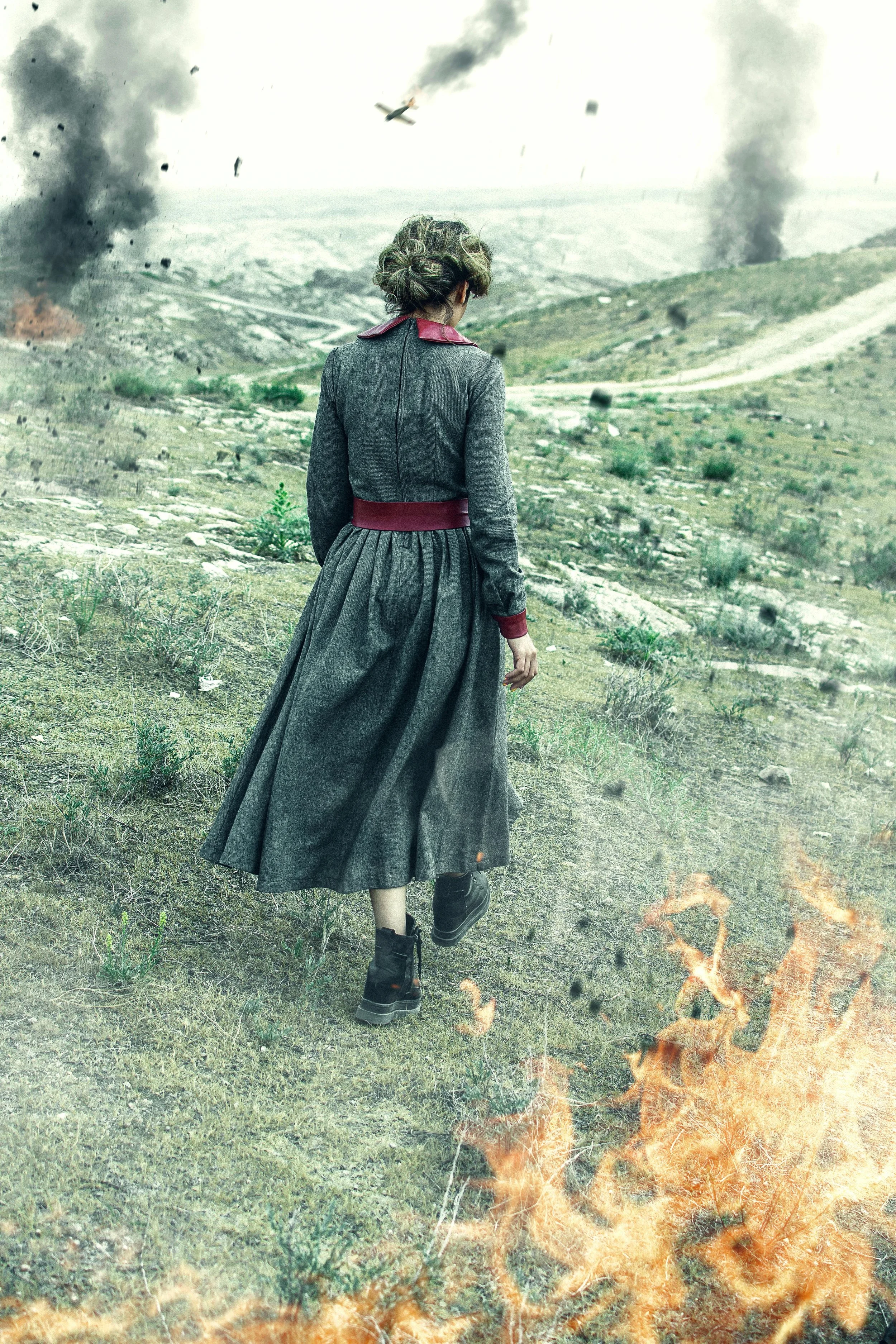 An image of a woman walking through a battlefield symbolizes the experience of a highly sensitive therapist attempting to stay grounded while the world feels devastating