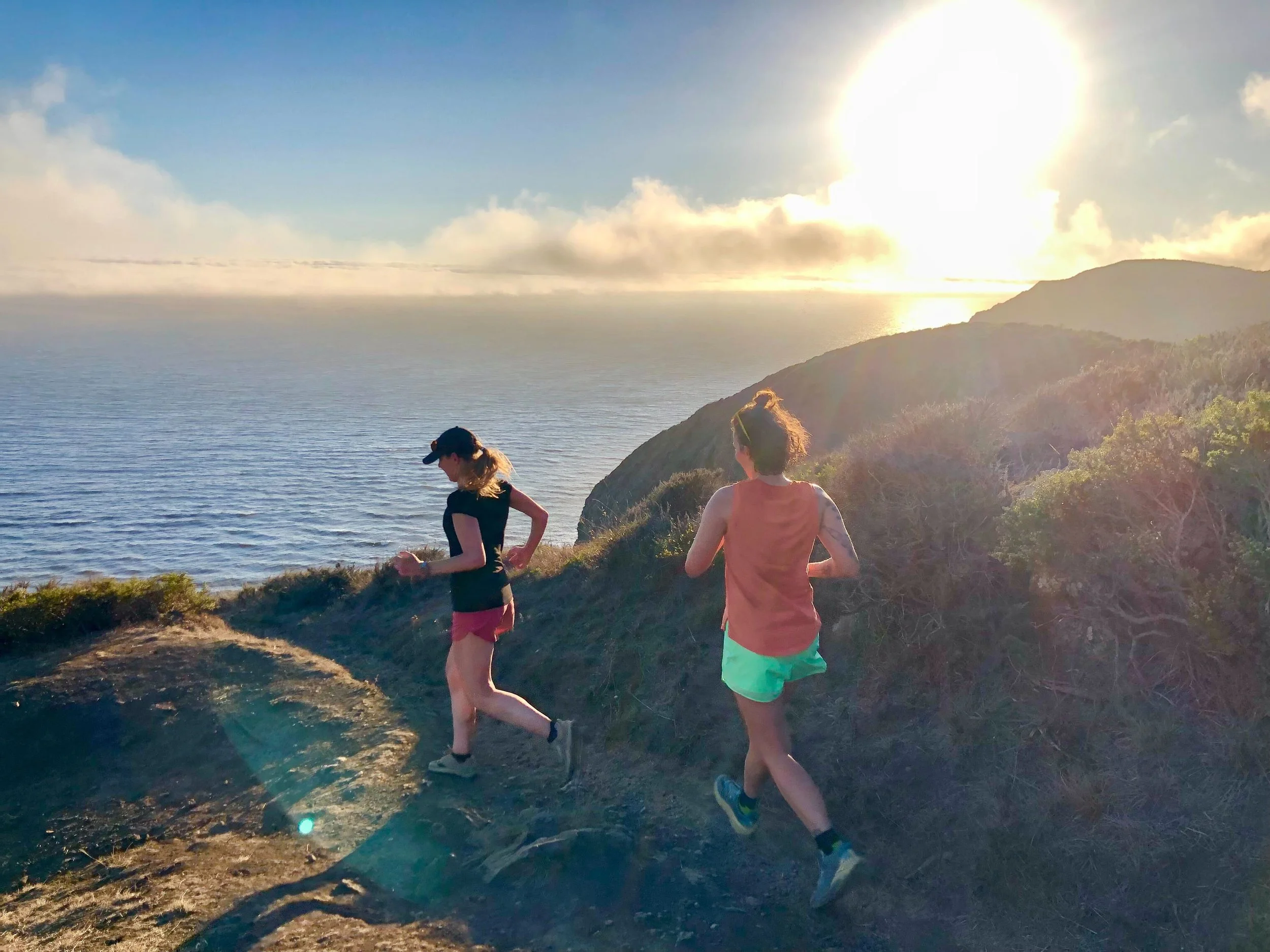 Dr. Amy Waldron is shown running on a trail with a fellow social worker. Dr. Amy Waldron is a trail runner and a one of the leaders of a local trail running community.