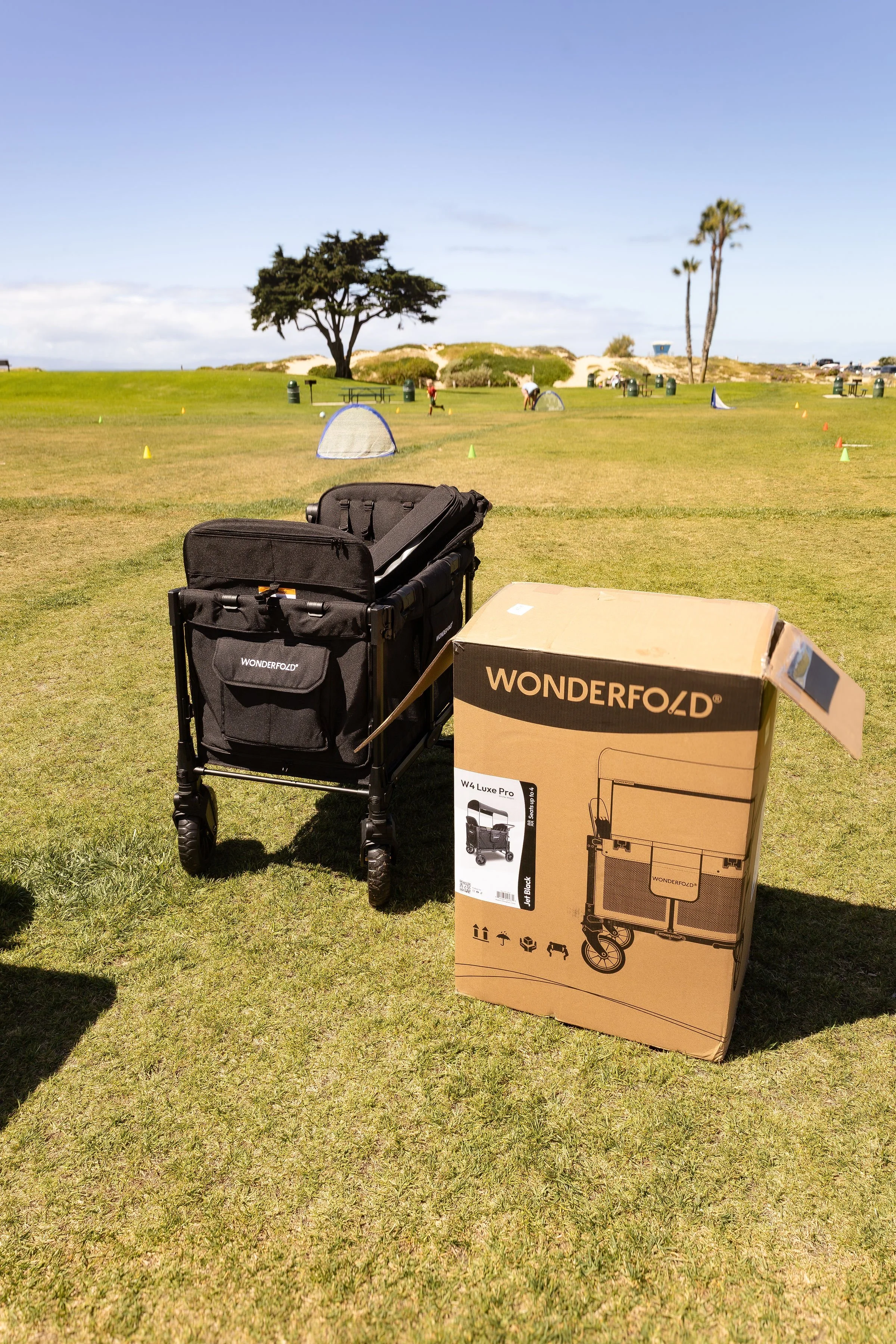 Wonderfold Wagon W Series open by box in park.