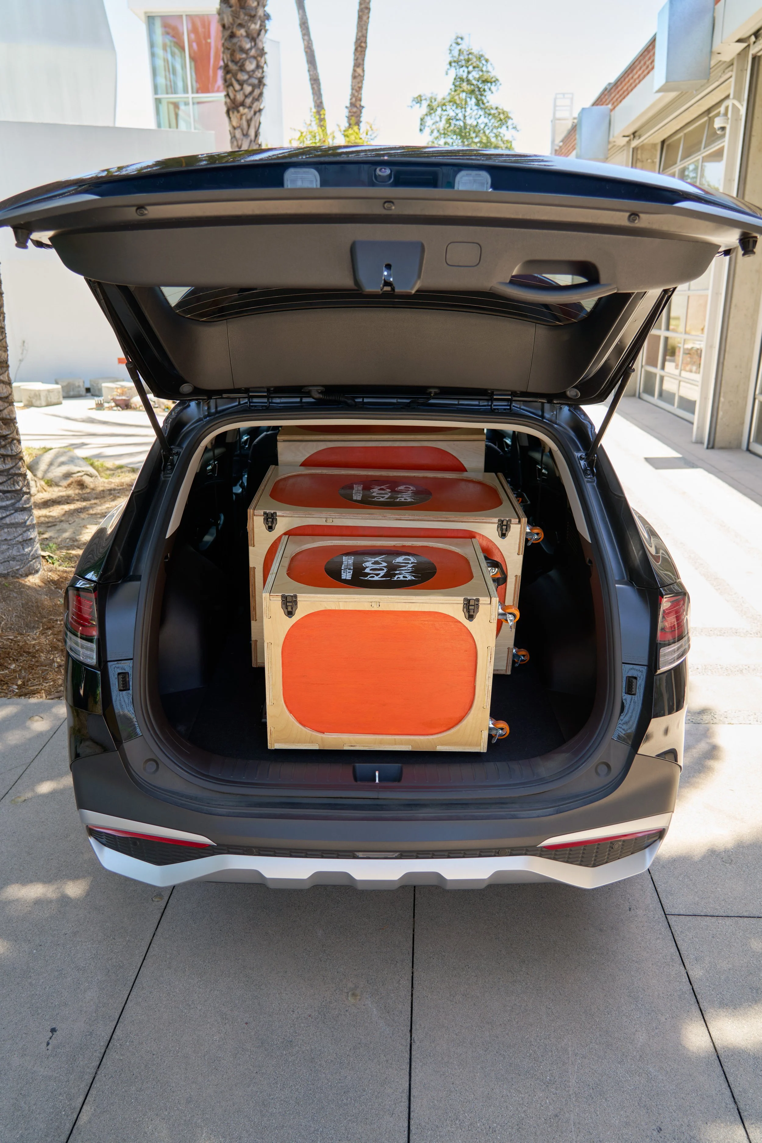 drum cases in the back of a hatchback with trunk open