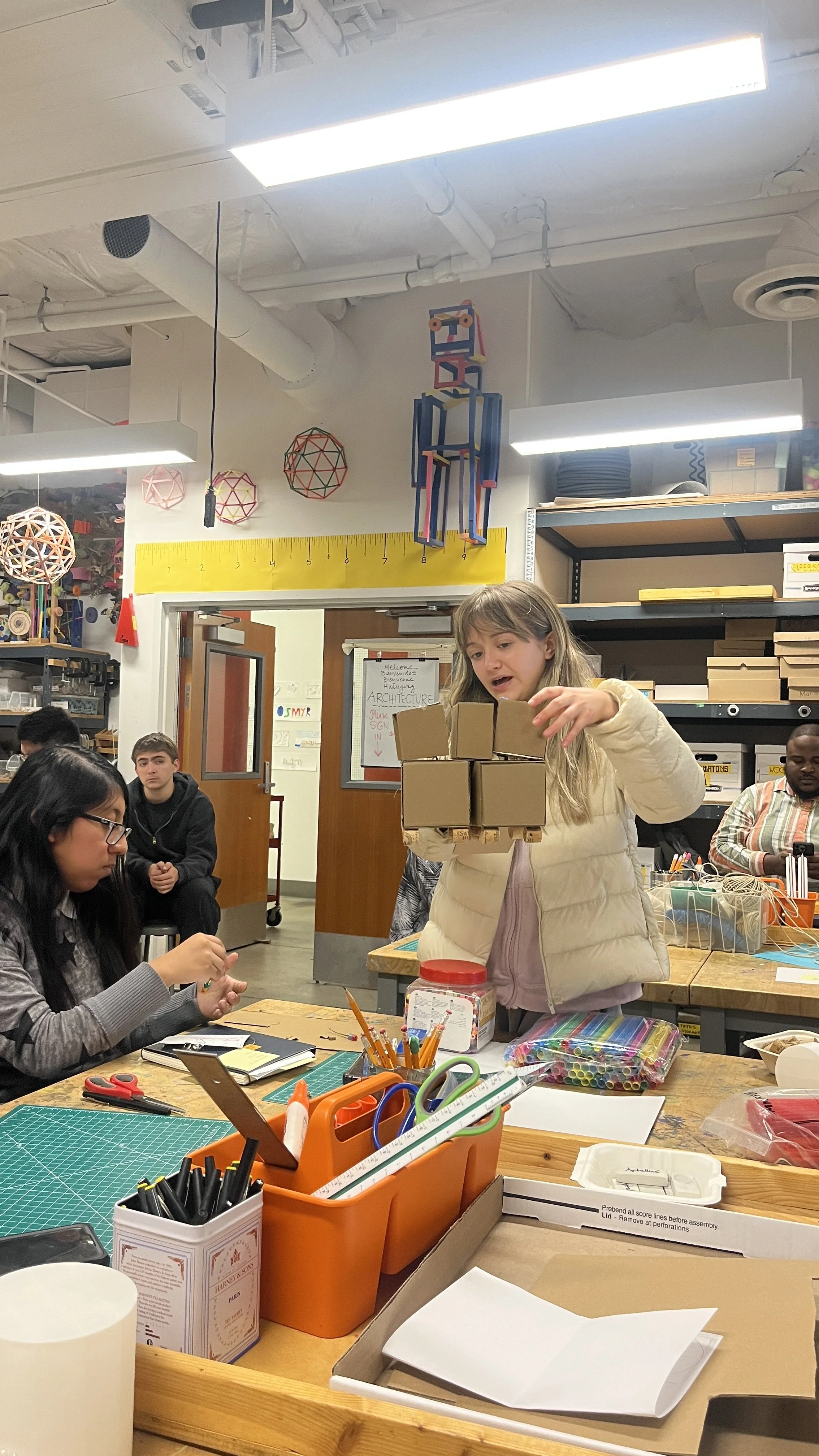Student holds up cardboard model