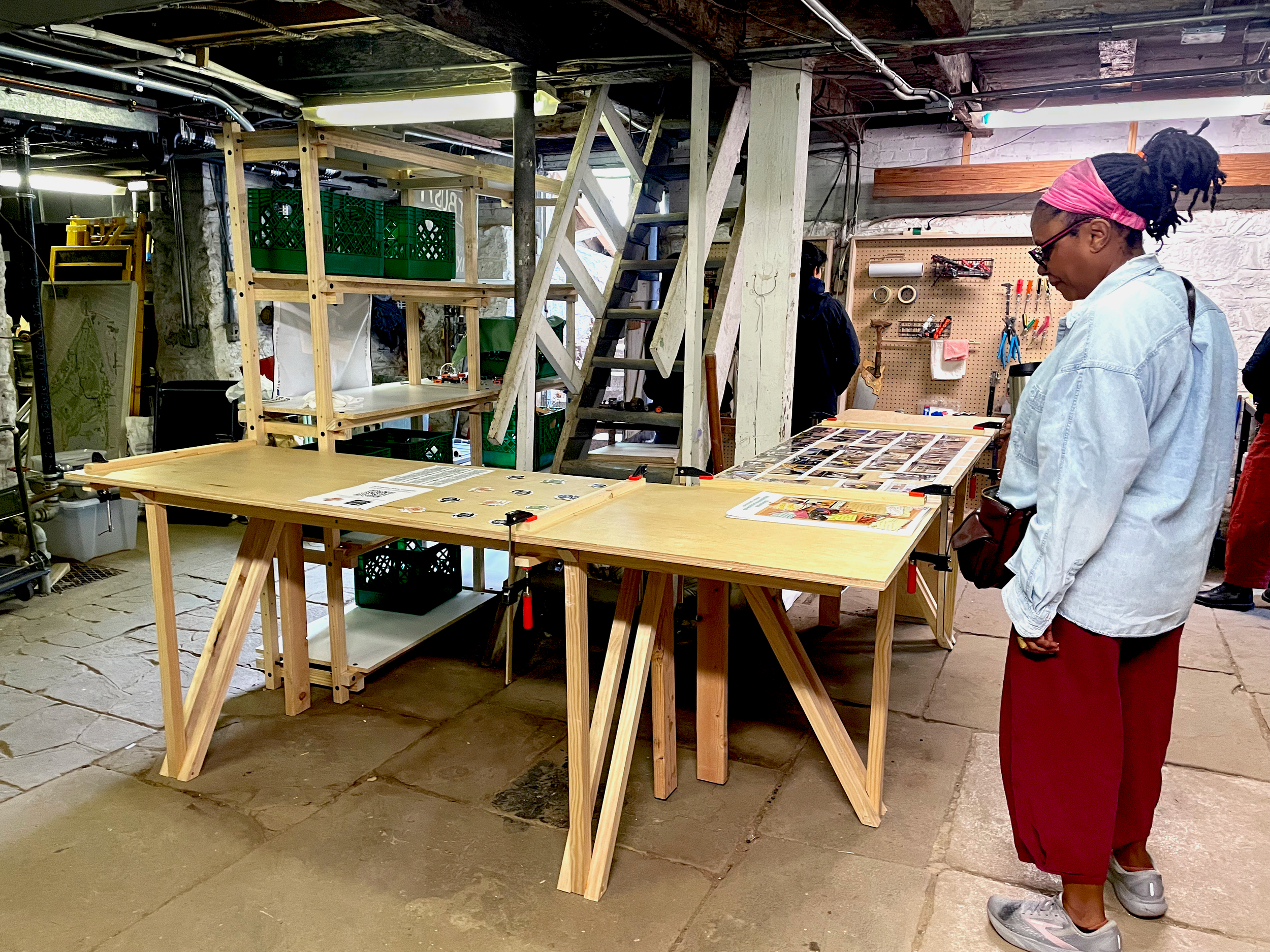 Basement tool Library with work tables, shelves, and pegboards with tools hanging