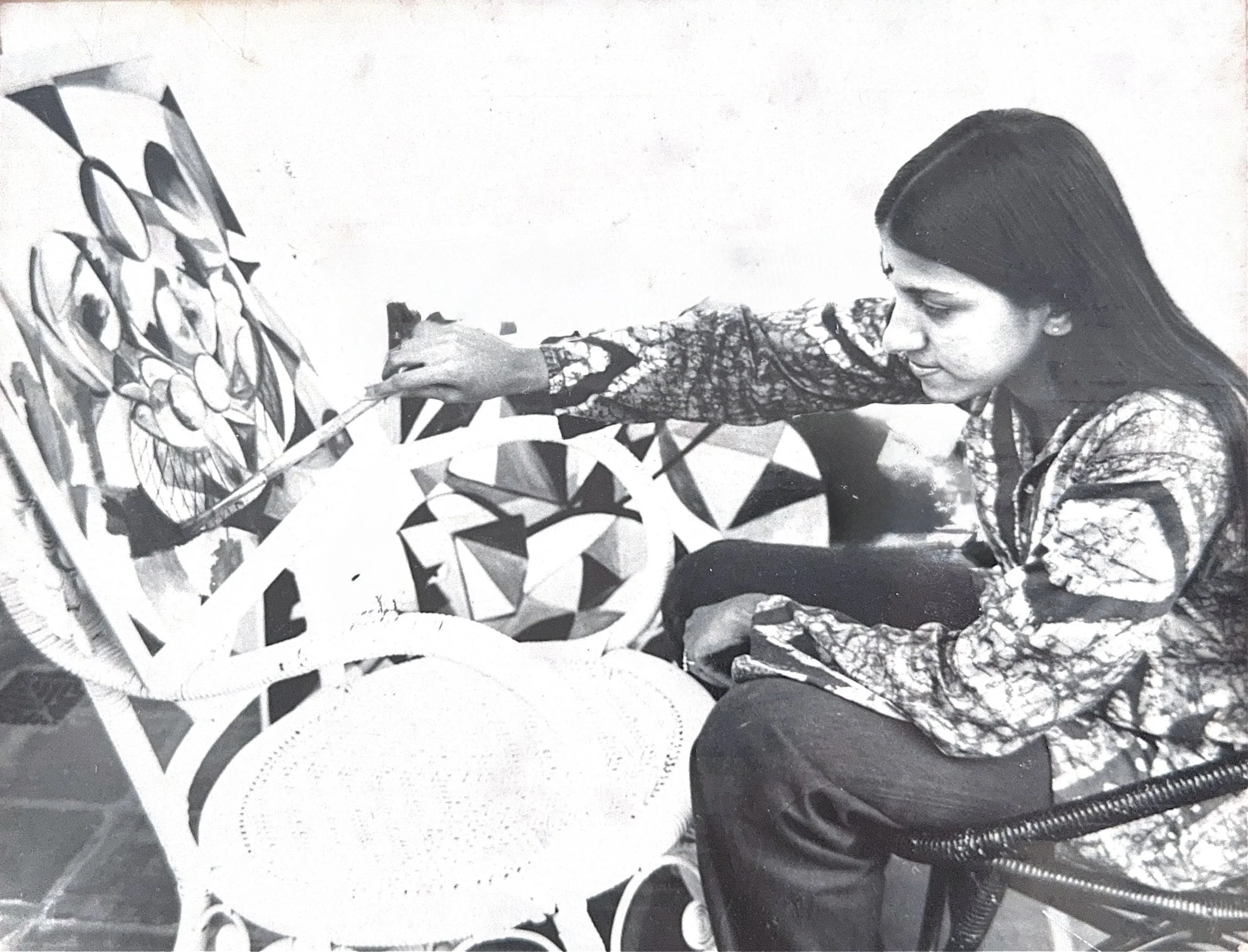 Artist Leilani Jeevaratnam painting an abstract botanical canvas.
