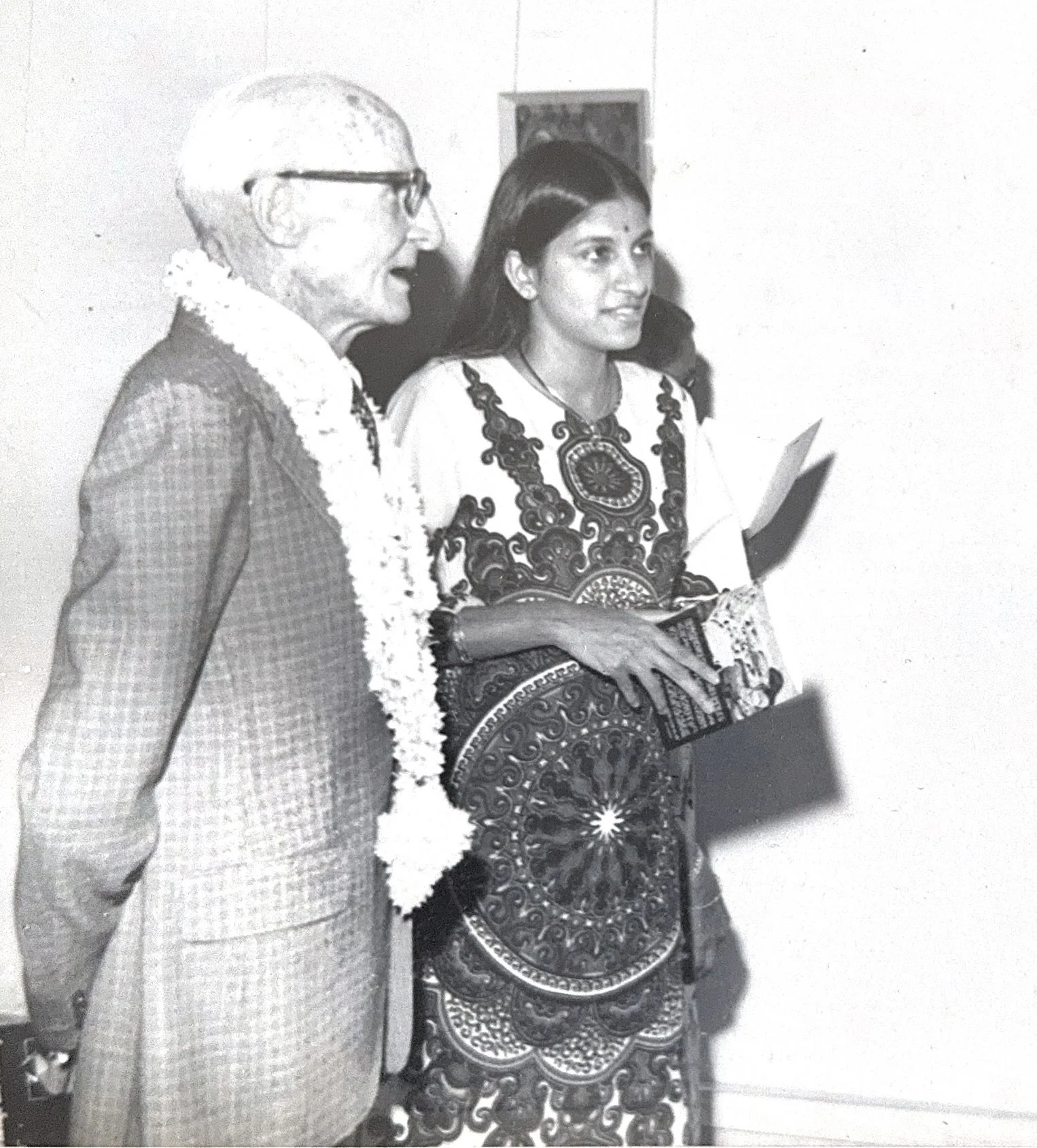 The artist with the French Cultural Ambassador viewing one of her paintings during her first solo exhibition, over 46 years ago — a moment of exchange and appreciation for her early work.