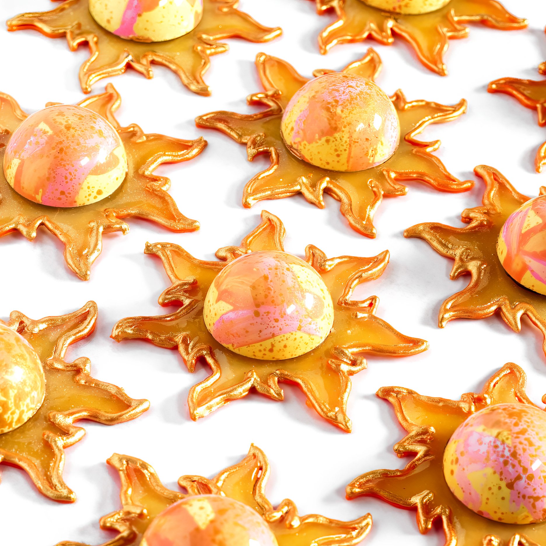 Hand-painted with cheerful splashes of custom-dyed cocoa butter and filled with gooey salted caramel, these bonbons radiate warmth. Each sugar-sculpted ray was shaped by hand, making them as joyful to look at as they are to eat.