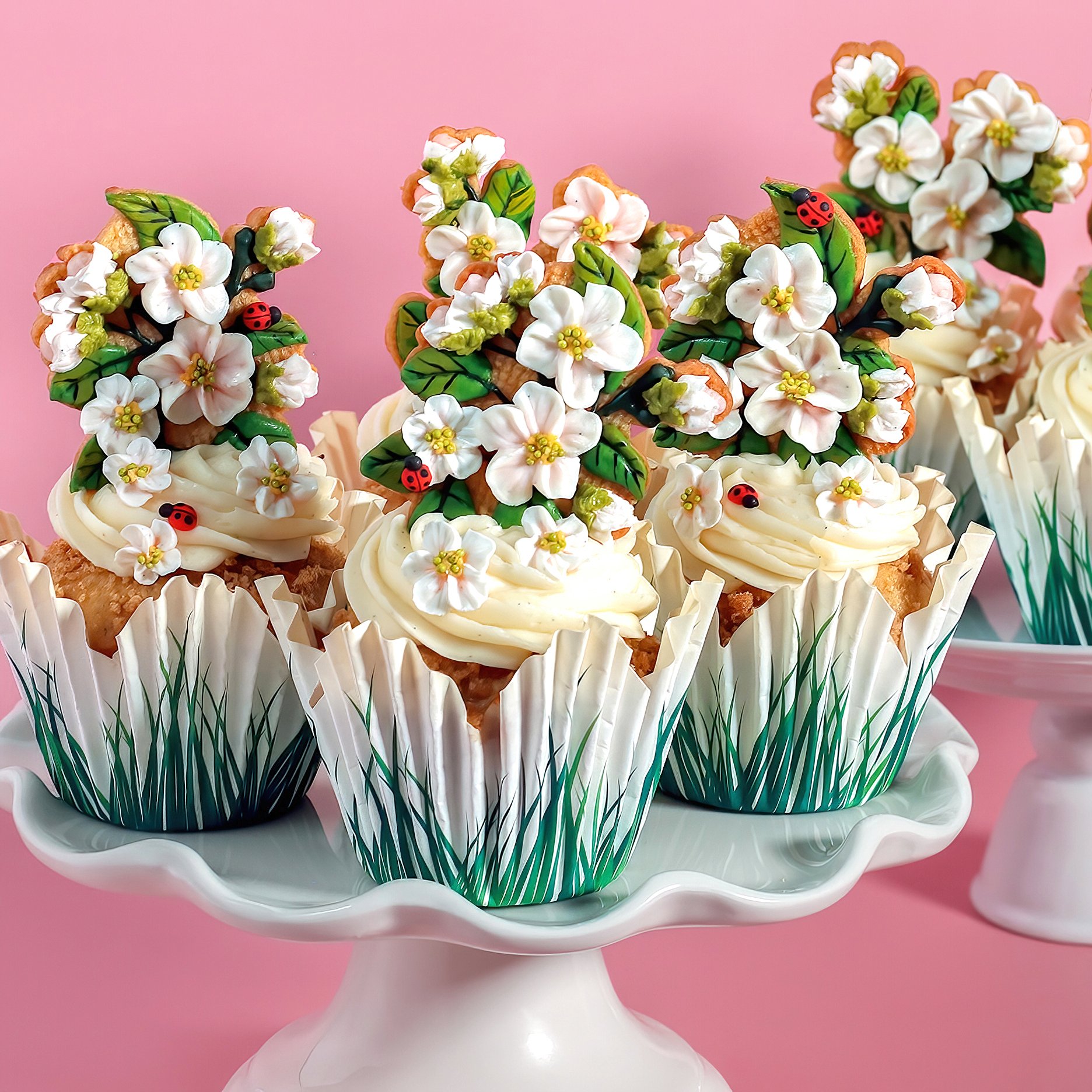 Over-the-top in the best way, these cinnamon-apple cupcakes are stacked with swoops of cream cheese frosting, royal icing ladybugs, and ornate apple blossom cookies—like a woodland tea party dressed up for spring.