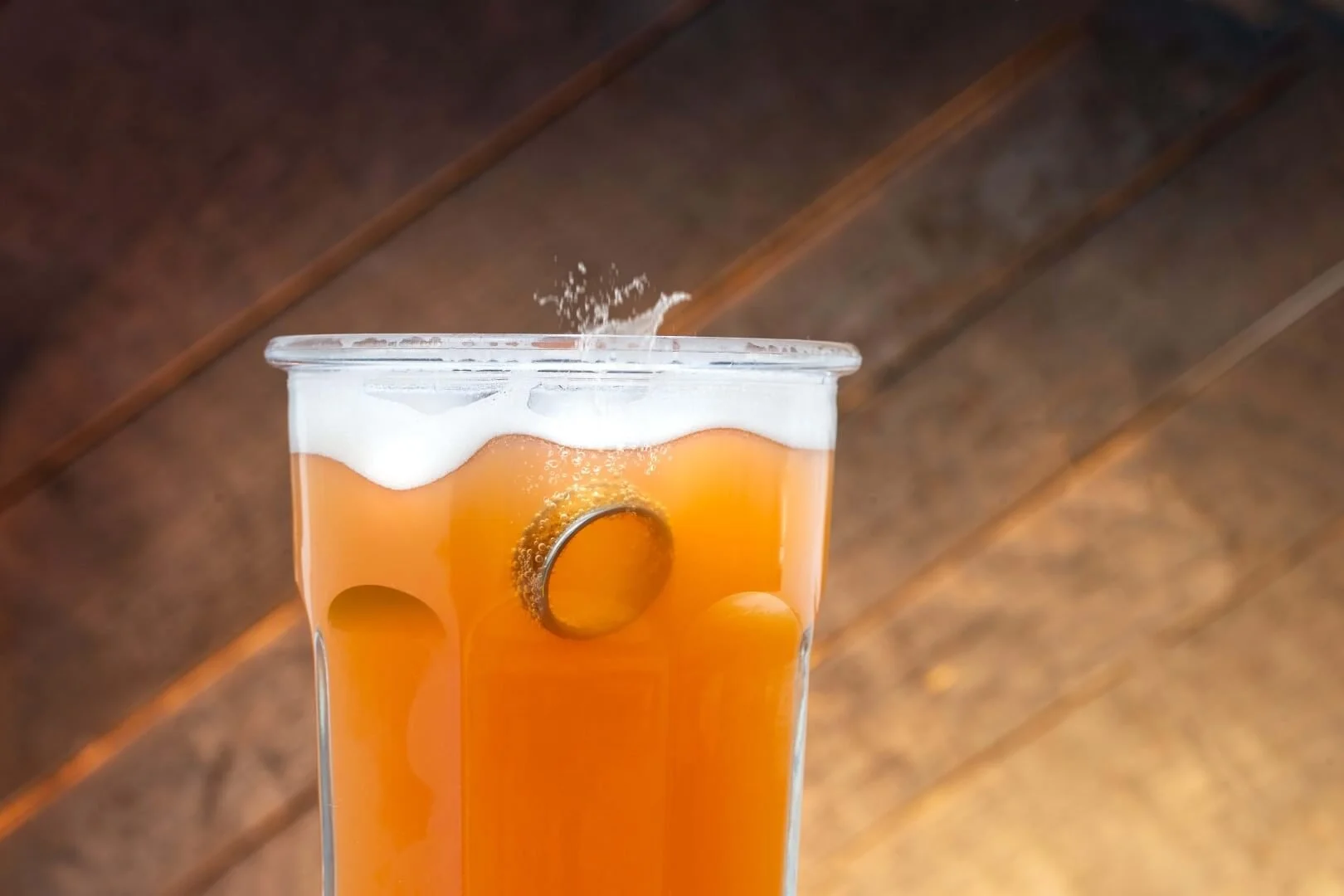 This "splash" was created by hanging the ring with fishing line and manipulating the beer in Photoshop.