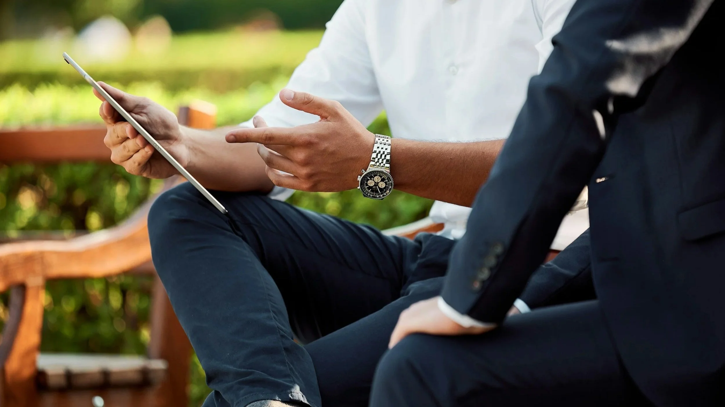 Two people sitting together having a coaching conversation about work.