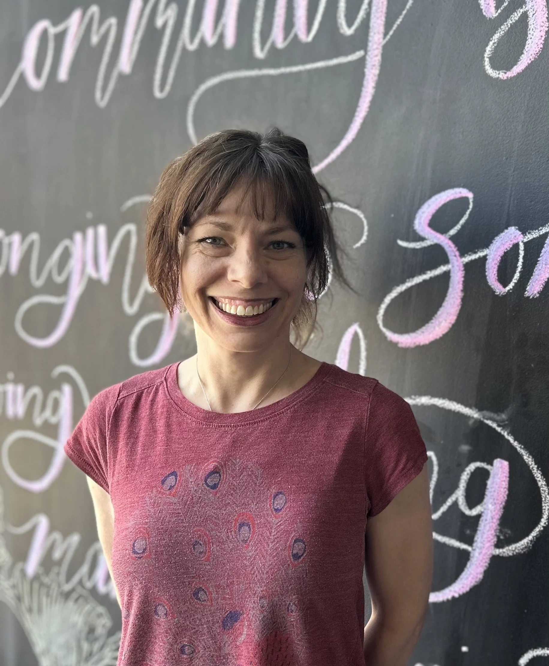 Woman with short dark hair smiling