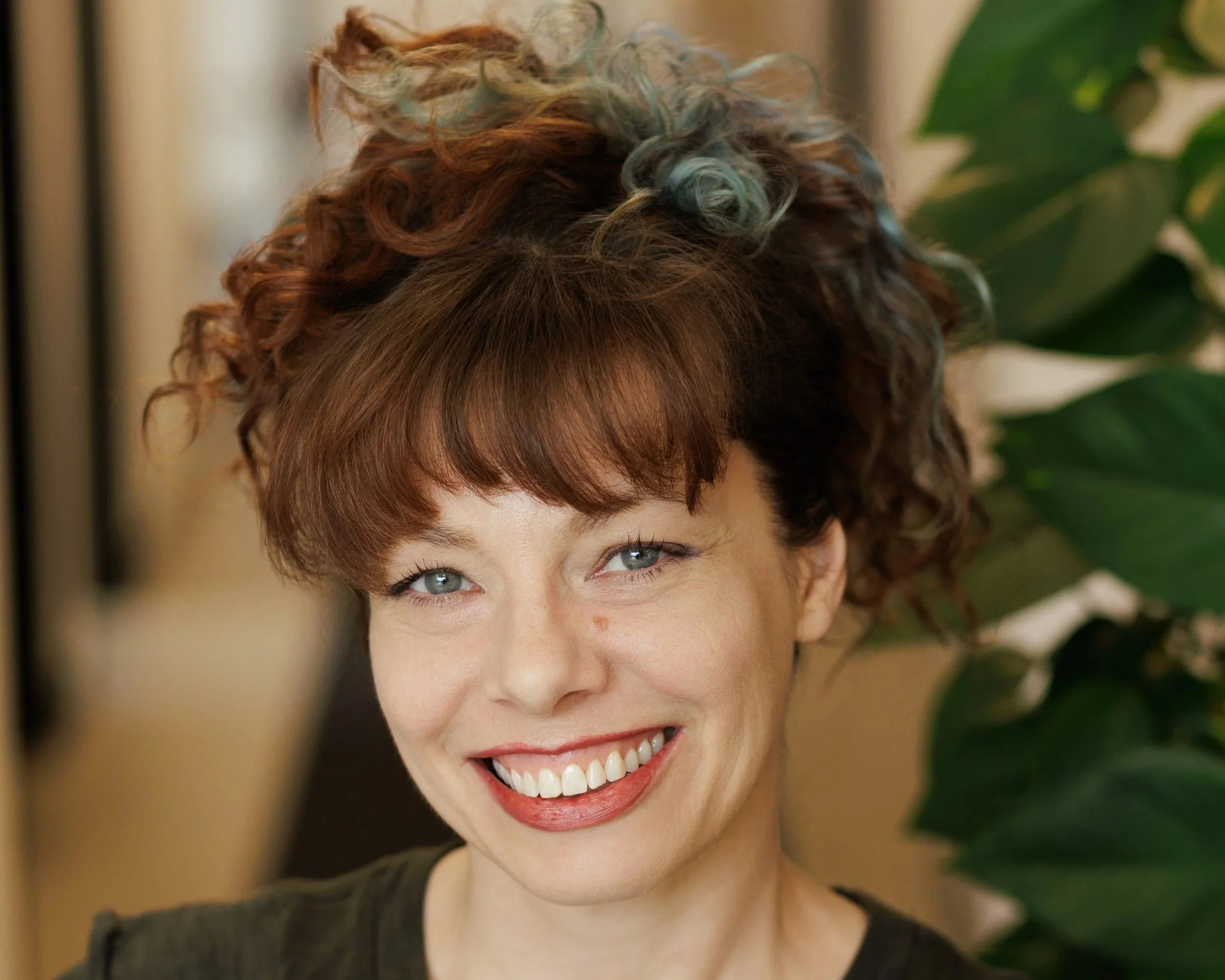 Woman with big smile wearing burgundy shirt